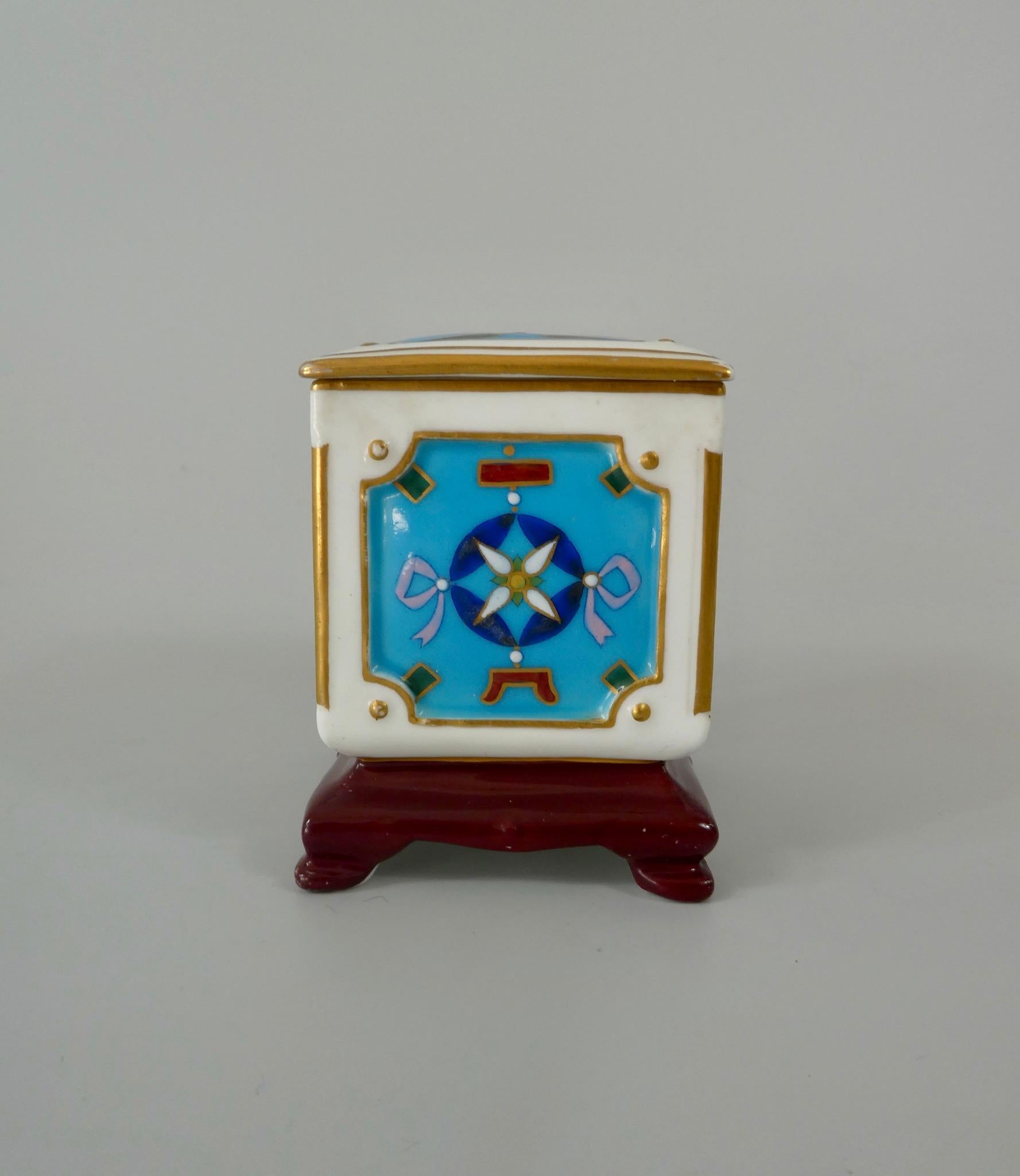 Minton porcelain box and cover, designed by Dr Christopher dresser, circa 1870. The moulded box, set upon an integral stand, decorated in Chinese cloisonne taste, with stylised floral motif, upon a turquoise ground, heightened in gilt. The cover