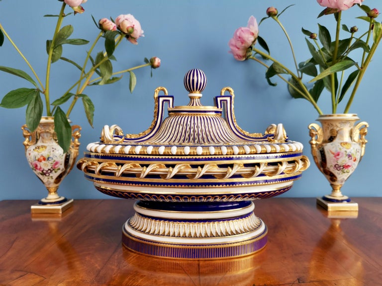 On offer is a sublime and very rare centre piece made by Minton between 1862 and 1870, which was the Victorian era. The centre piece is made in the Sèvres style and decorated in a mazarine or cobalt blue ground with rich and very fine gilding. The