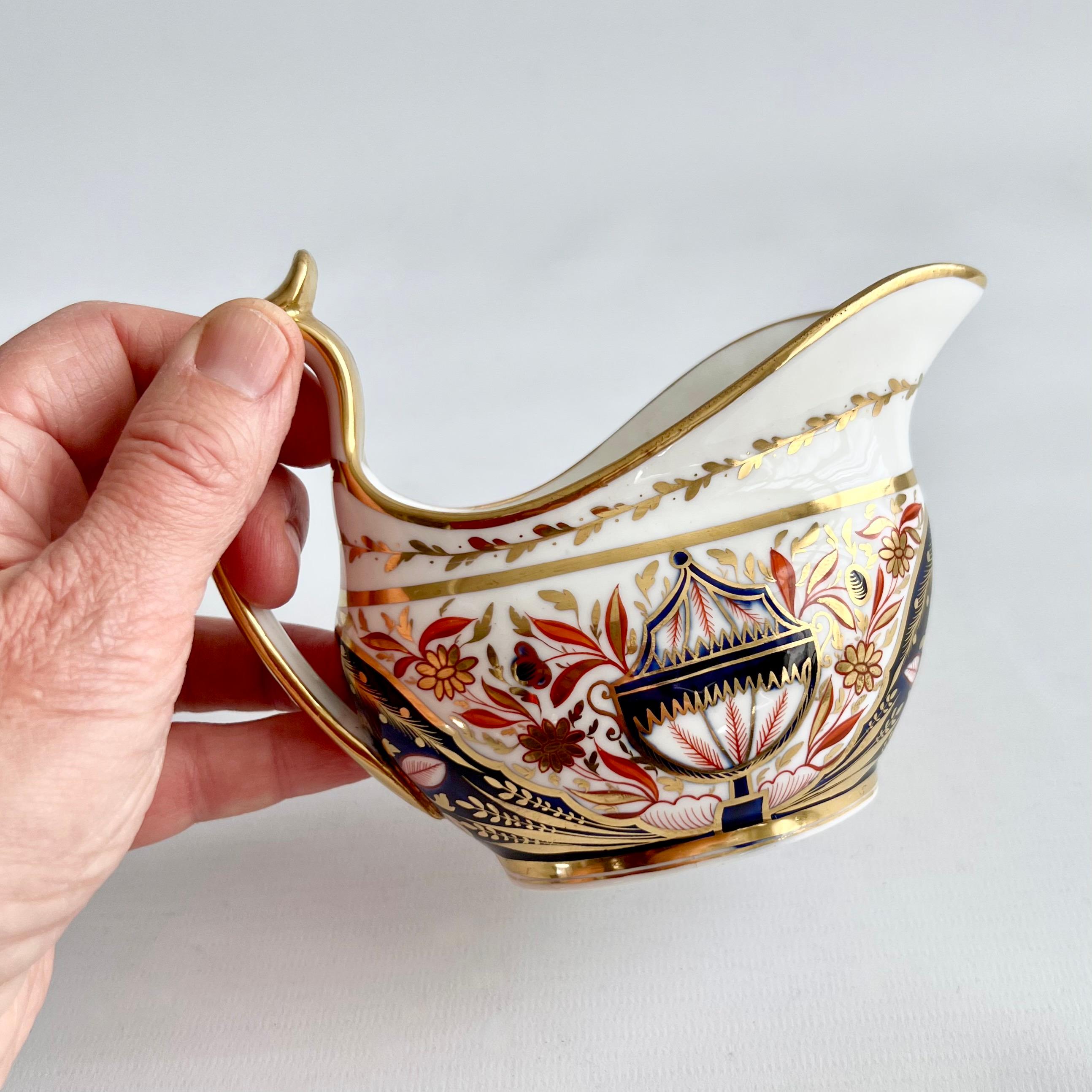 This is a beautiful and rare milk jug or creamer made by Minton in about 1810. The jug has a very beautiful neoclassical Imari pattern with the number 202.

Minton was one of the pioneers of English china production alongside other great potters