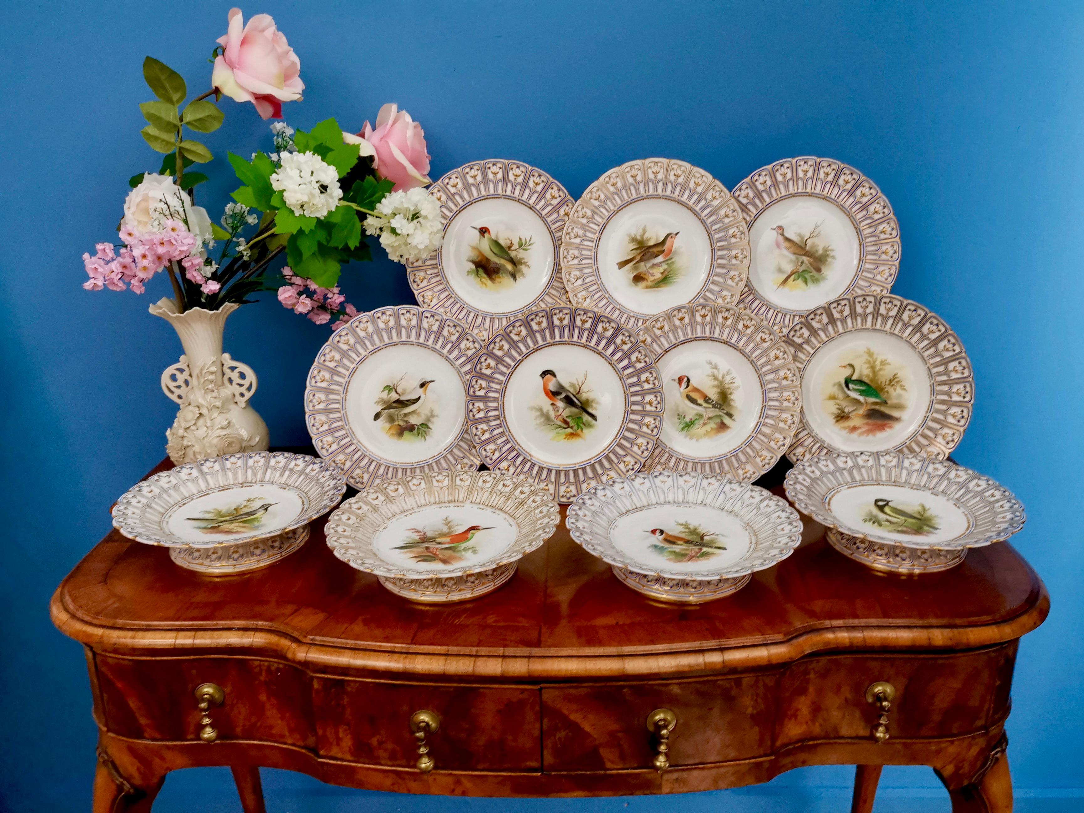 This is a stunning porcelain dessert service made by Minton in 1851, which was the Victorian era. It has hand painted named birds by the famous painter Joseph Smith, and a beautiful reticulated border called the 