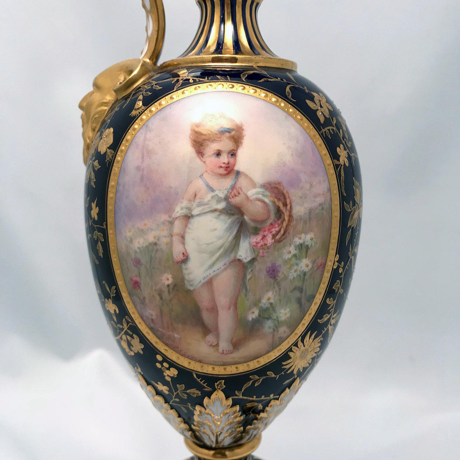 This is surely among Minton's best work this elegant jug is in cobalt blue, sumptuously gilt with trailing leaves, and a mask, jeweled at the neck, and on a square gilt base. The oval reserve is charmingly painted with a little girl in a garden. No