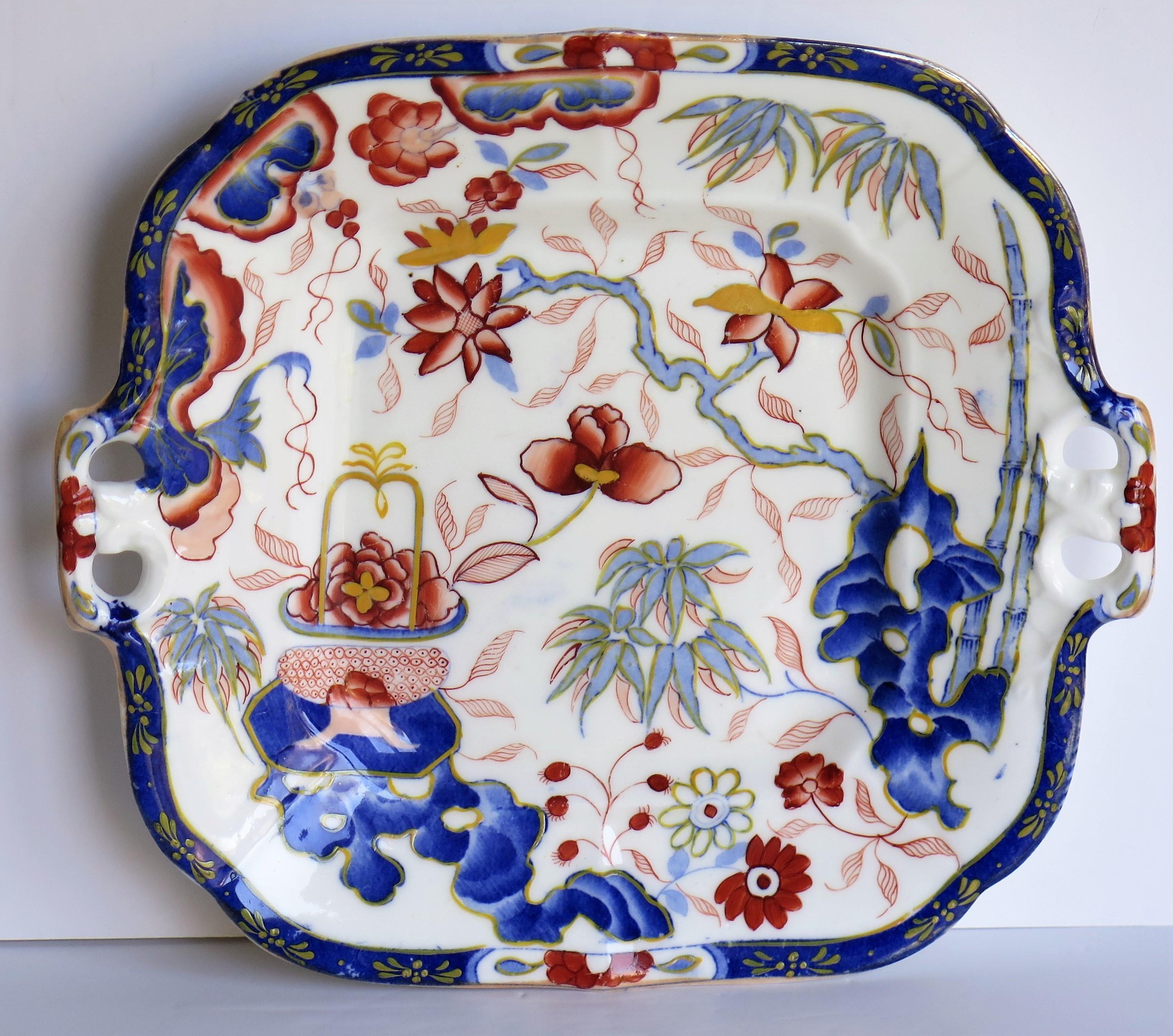 This is a hand painted porcelain handled dish or plate in chinoiserie pattern 1052, made by Minton of Stoke, England, circa 1825.

The dish is very well potted in a square slightly fluted shape with moulded side handles and sitting on a low