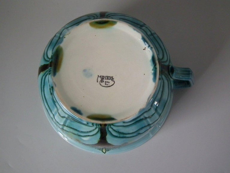 Minton Secessionist chamber pot. Decorated with motifs in the Art Nouveau style. Glazed in turquoise, ochre, brown and blue. Green tube lining. Maker's marks to underside including printed, 'MINTONS LTD.', impressed 'MINTONS' and date cipher for