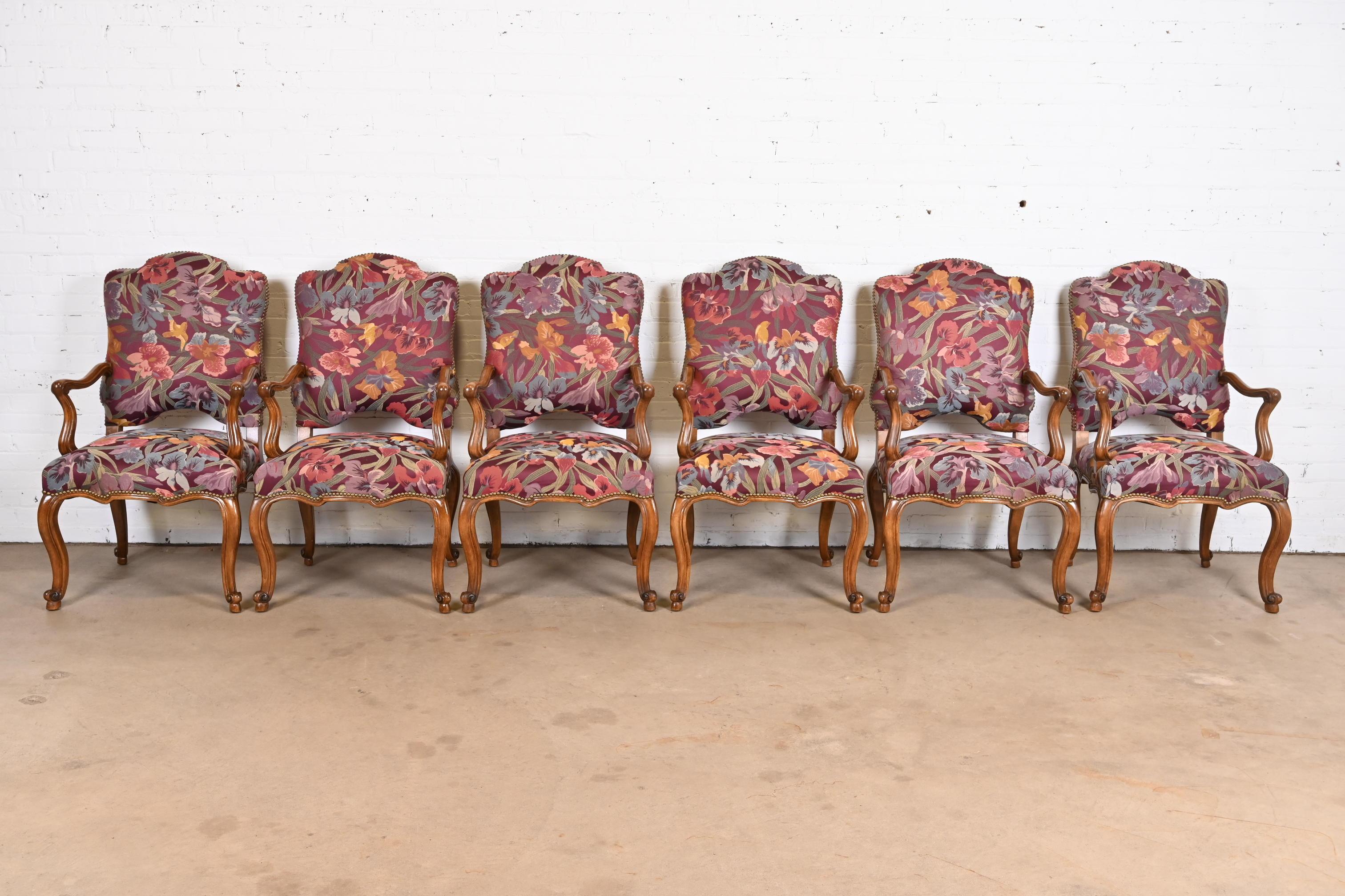 An exceptional set of six French Provincial Louis XV style dining armchairs

By Minton Spidell

USA, Late 20th Century

Solid carved walnut frames, with brass studded floral tapestry upholstery. 

Measures: 24.25