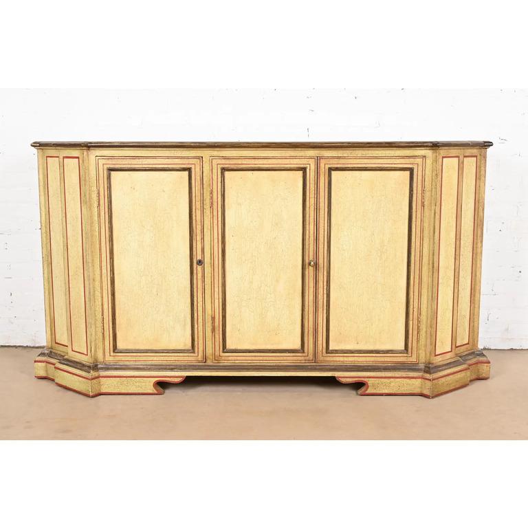 An exceptional French Regency Louis XVI style sideboard, credenza, or bar cabinet

By Minton Spidell

USA, Circa Late 20th Century

Cream crackle lacquered case, with red and olive green trim, and red lacquered interior. 

Measures: 72