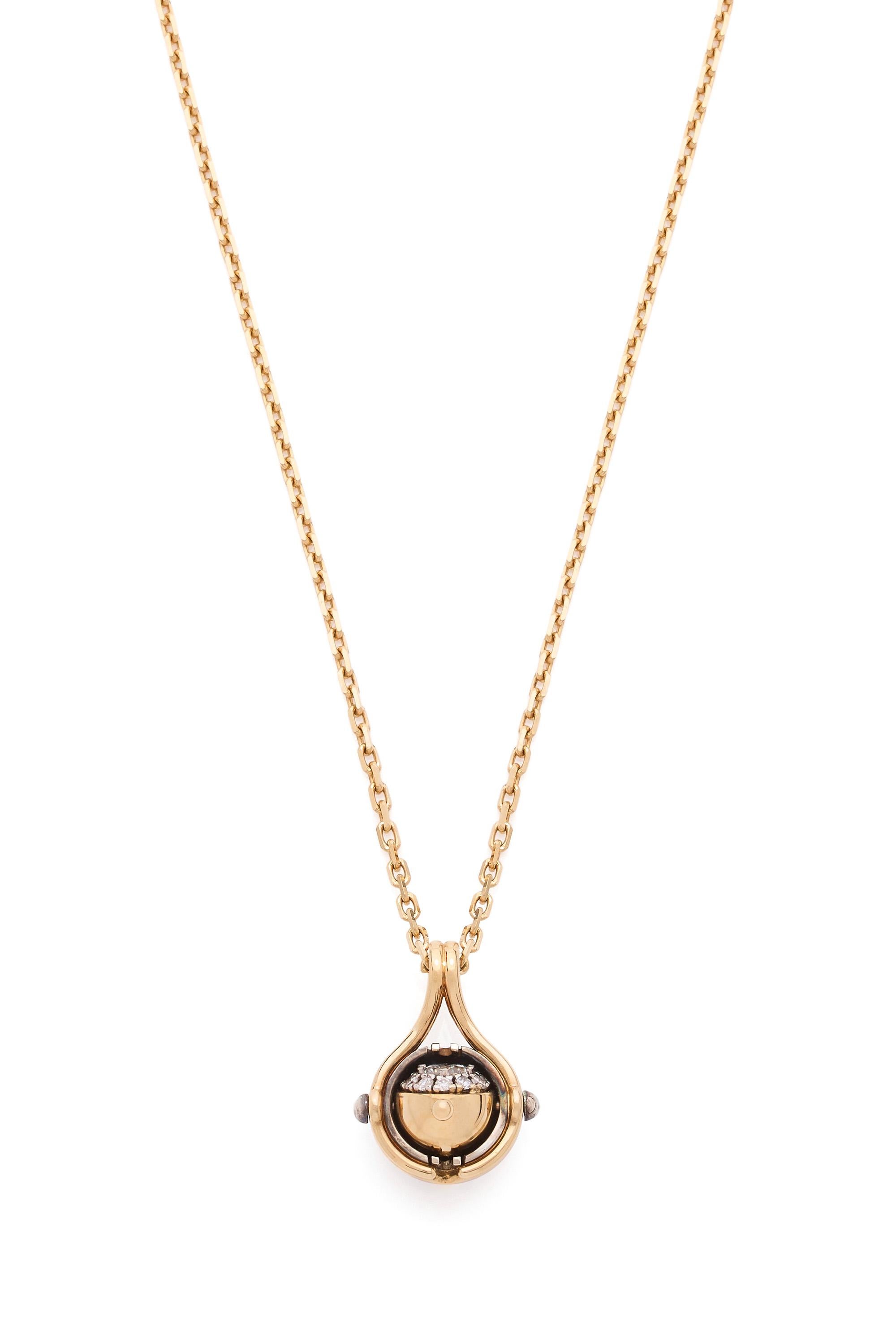 Gold and distressed silver pendant. Rotating sphere revealing a diamond surrounded by diamonds.

Sold with chain. 

Details:
Central Diamond: 0.25 cts
12 Diamonds: 0.15 cts
18k Gold: 6.65 g with chain
Distressed Silver: 1.5 g
Made in France