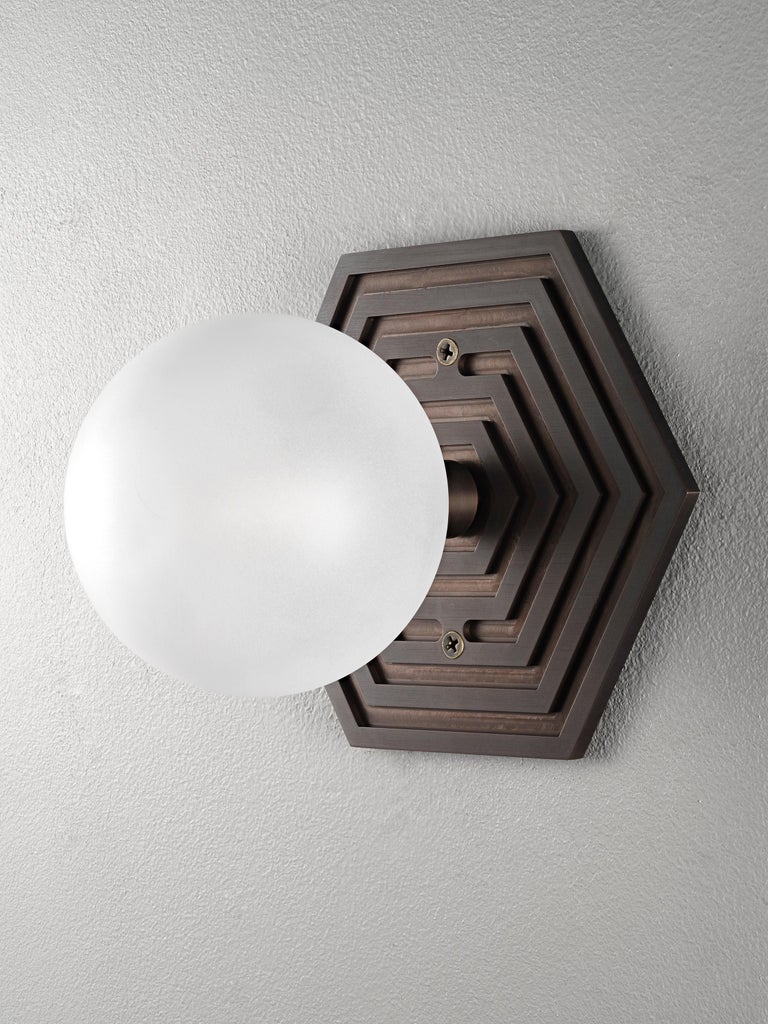 MIRA HEX wall sconce in solid brass with oil-rubbed bronze finish and blown opal glass by Blueprint Lighting, 2022.
A handsome study in clean lines and simple form inspired by the both the Machine Age and Art Deco periods, the Mira Hex is truly a