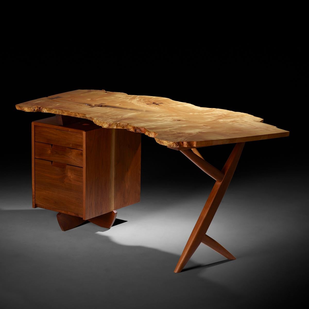 The desk features a dramatic figured burl top with three rosewood butterflies, knots and natural fissures. There are three drawers, one containing file storage. Signed, dated and inscribed to underside 