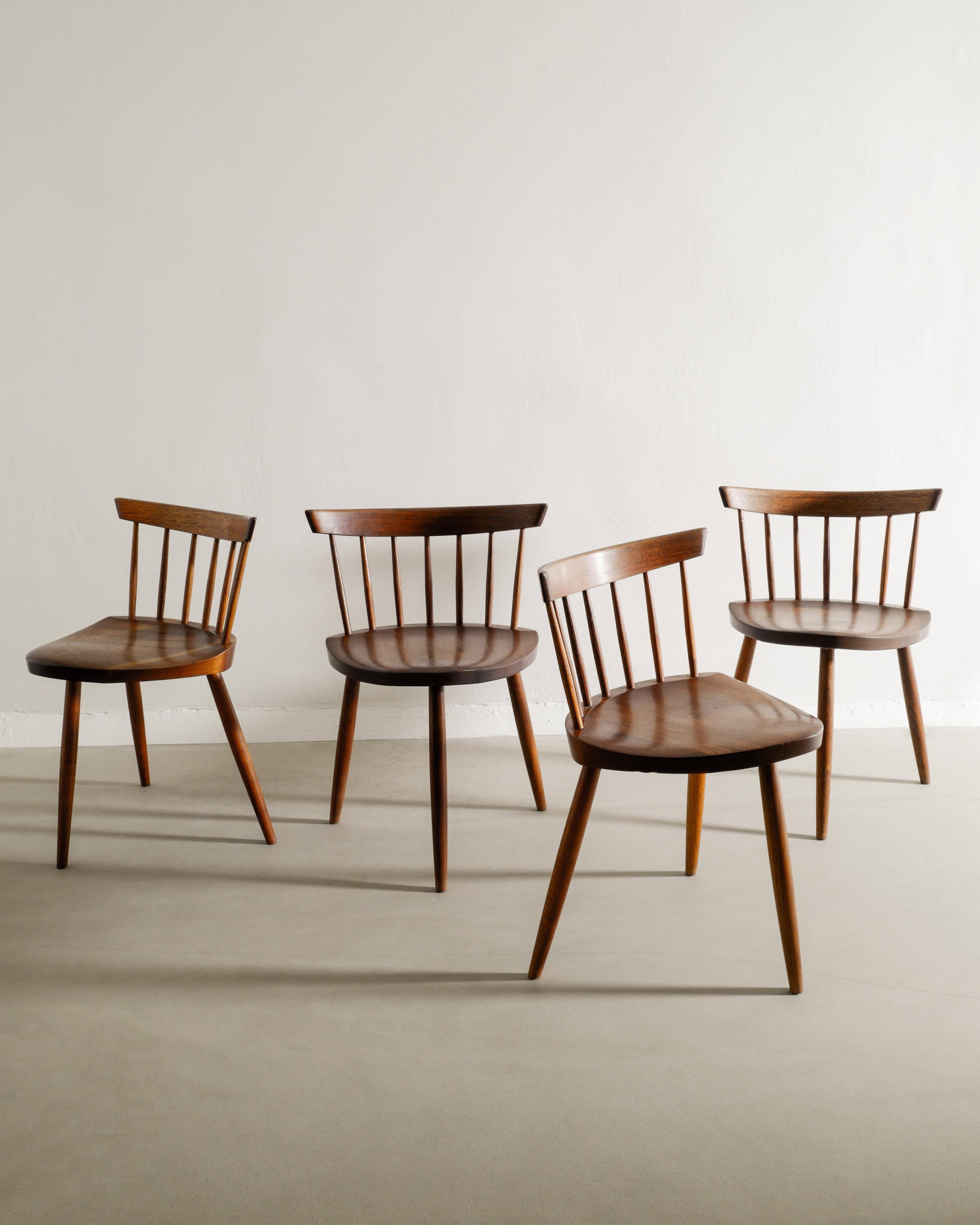 Very rare and great set of four wooden tripod dining chairs in walnut by Mira Nakashima produced as a custom order in 1963 by George Nakashima Woodworkers in Pennsylvania. In great original condition and comes with the original sales receipt in PDF.