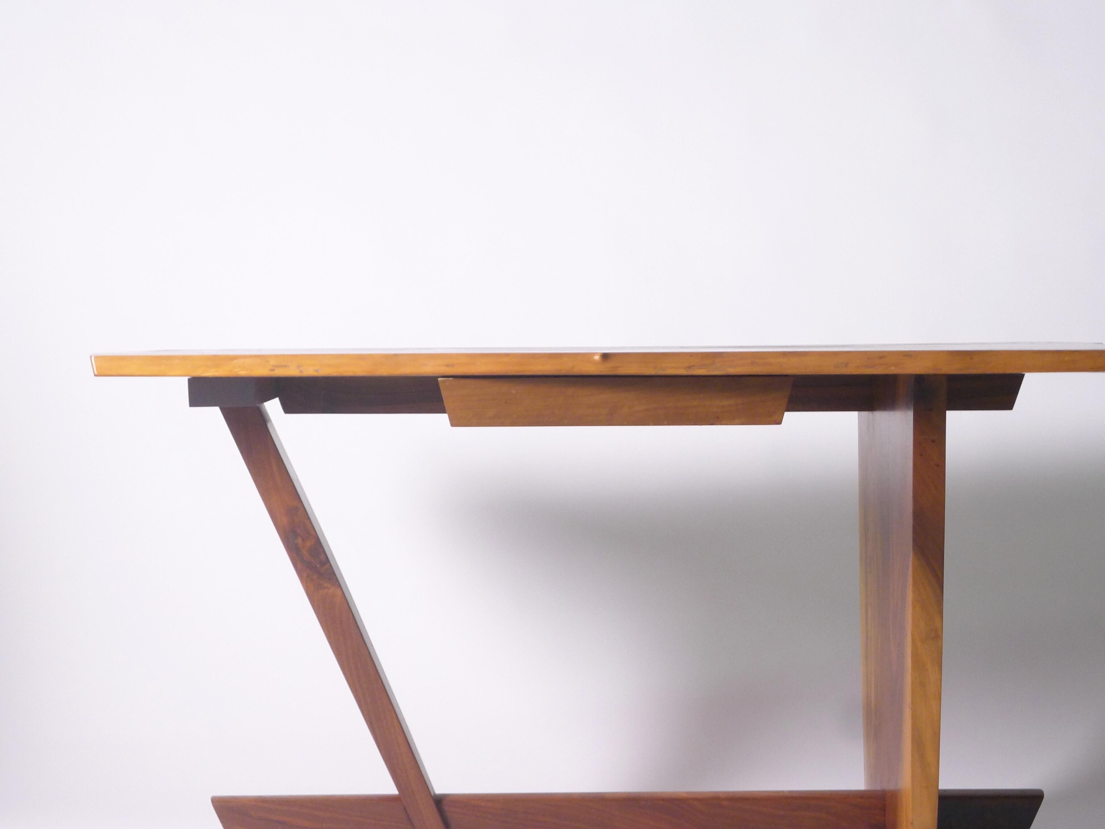 Large desk in American black walnut by Mira Nakashima, the single slab top with live edges, sap-grain detail, three rosewood butterflies, and one drawer concealing divided storage. 

152cm wide, 96cm wide (narrowing to 63cm at other end), 73cm
