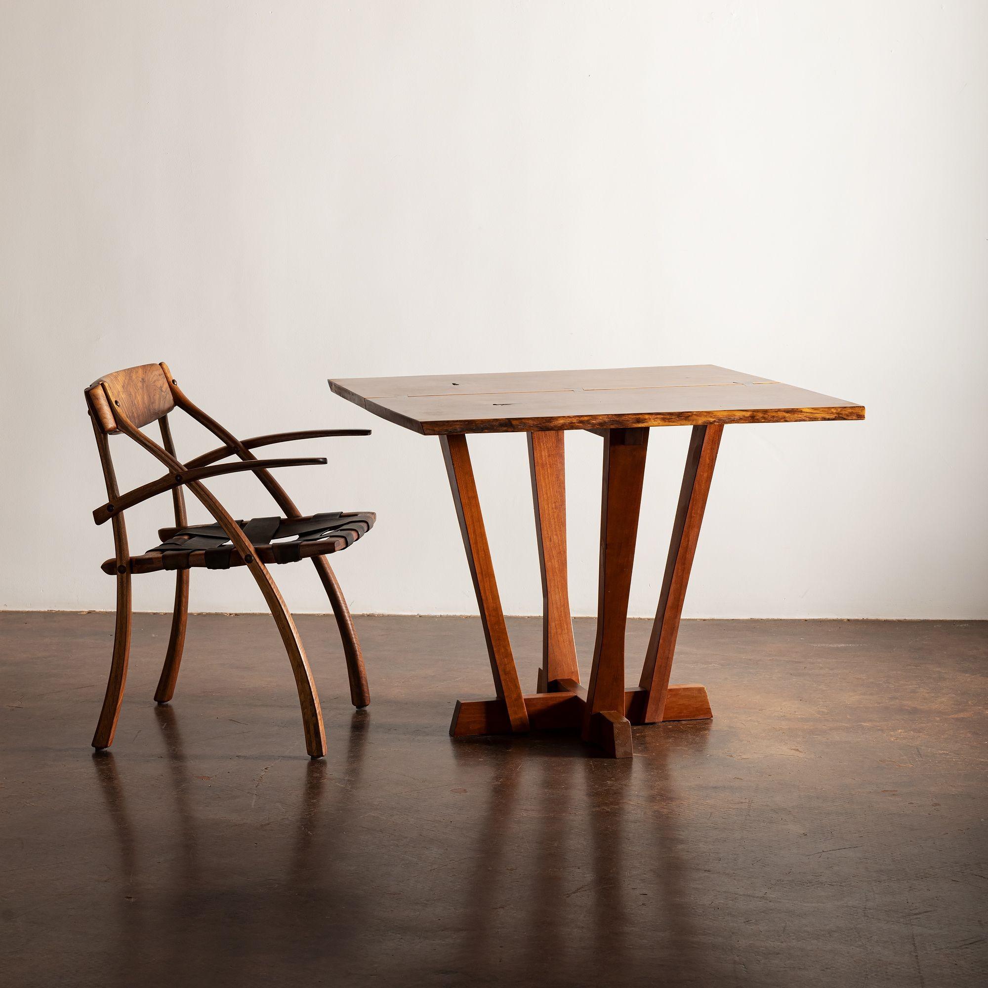 This unique piece by Mira Nakashima was custom-designed for the owner and the first of its kind. It features a book-matched top with exceptional grain, two free edges, two exposed knots, and three laurel butterflies. Signed and dated to underside