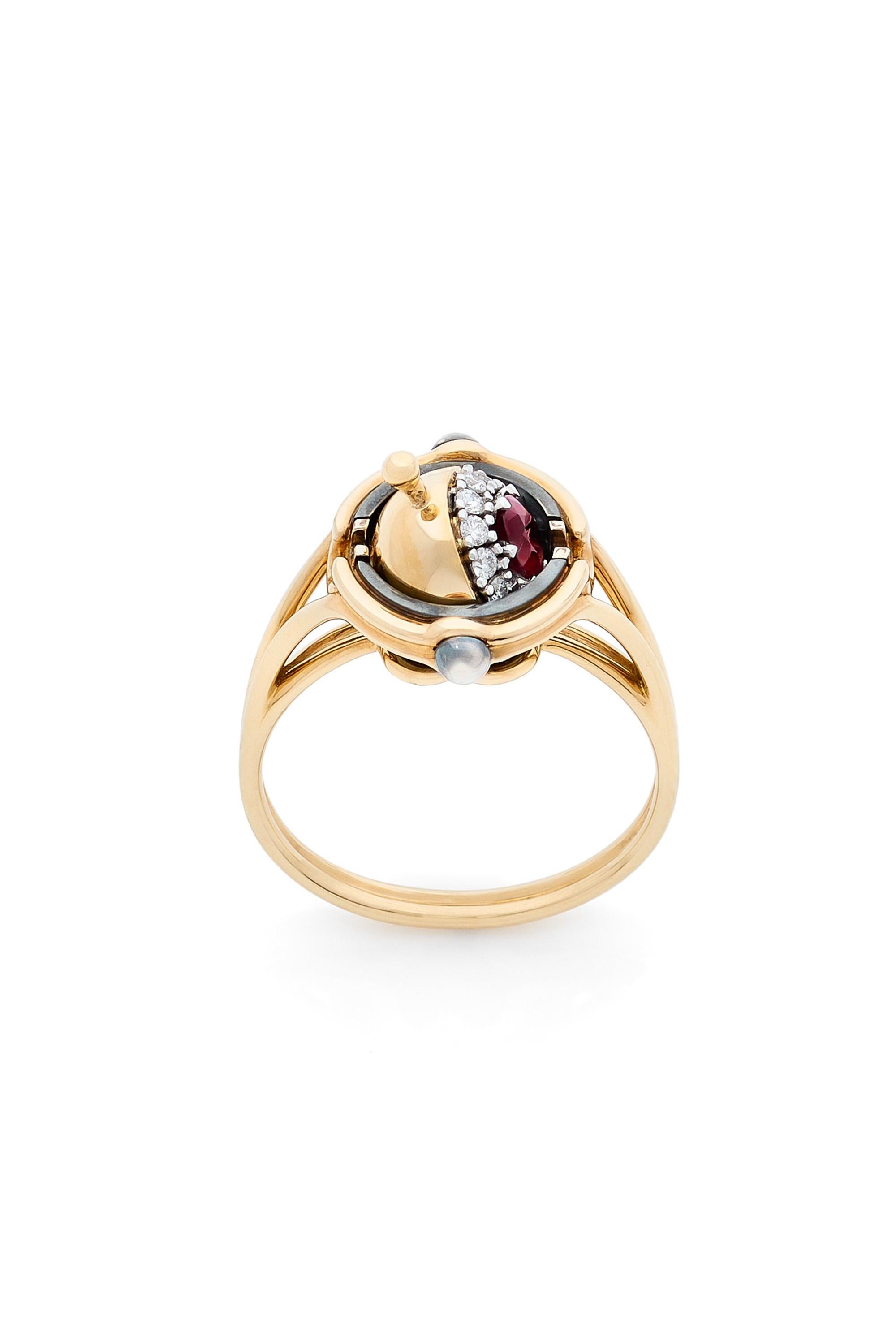 Gold and distressed silver ring. Rotating sphere revealing a ruby surrounded by diamonds.

Details:
Ruby: 0.30 cts
12 Diamonds: 0.15 cts
18k Gold: 5 g
Distressed Silver: 1.5 g
Made in France