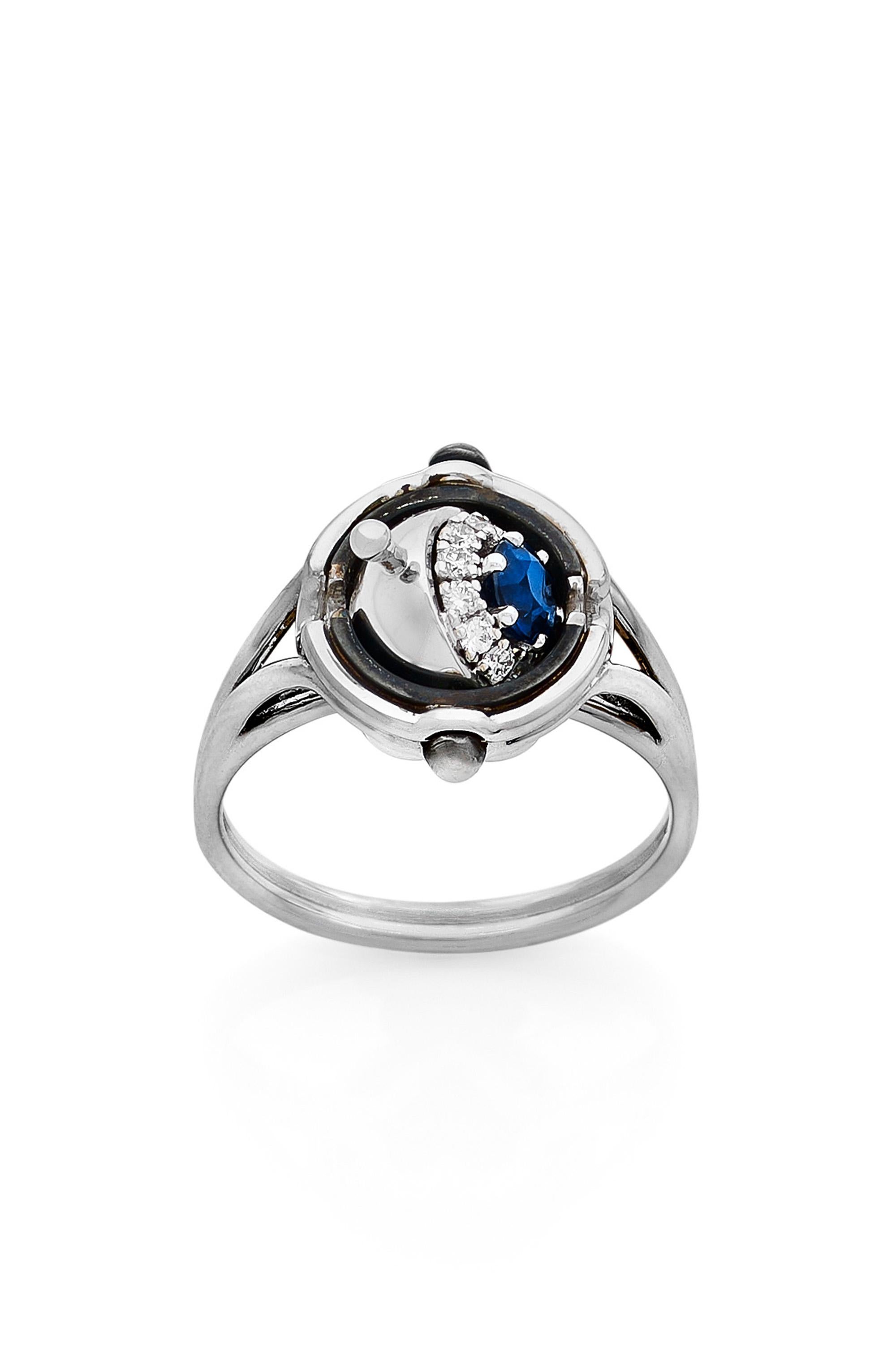 White gold and distressed silver ring. Rotating sphere revealing a sapphire surrounded by diamonds.

Details:
Sapphire: 0.30 cts, ø 4mm
12 Diamonds: 0.15 cts
18k White Gold: 5 g
Distressed Silver: 1.5 g
Made in France
