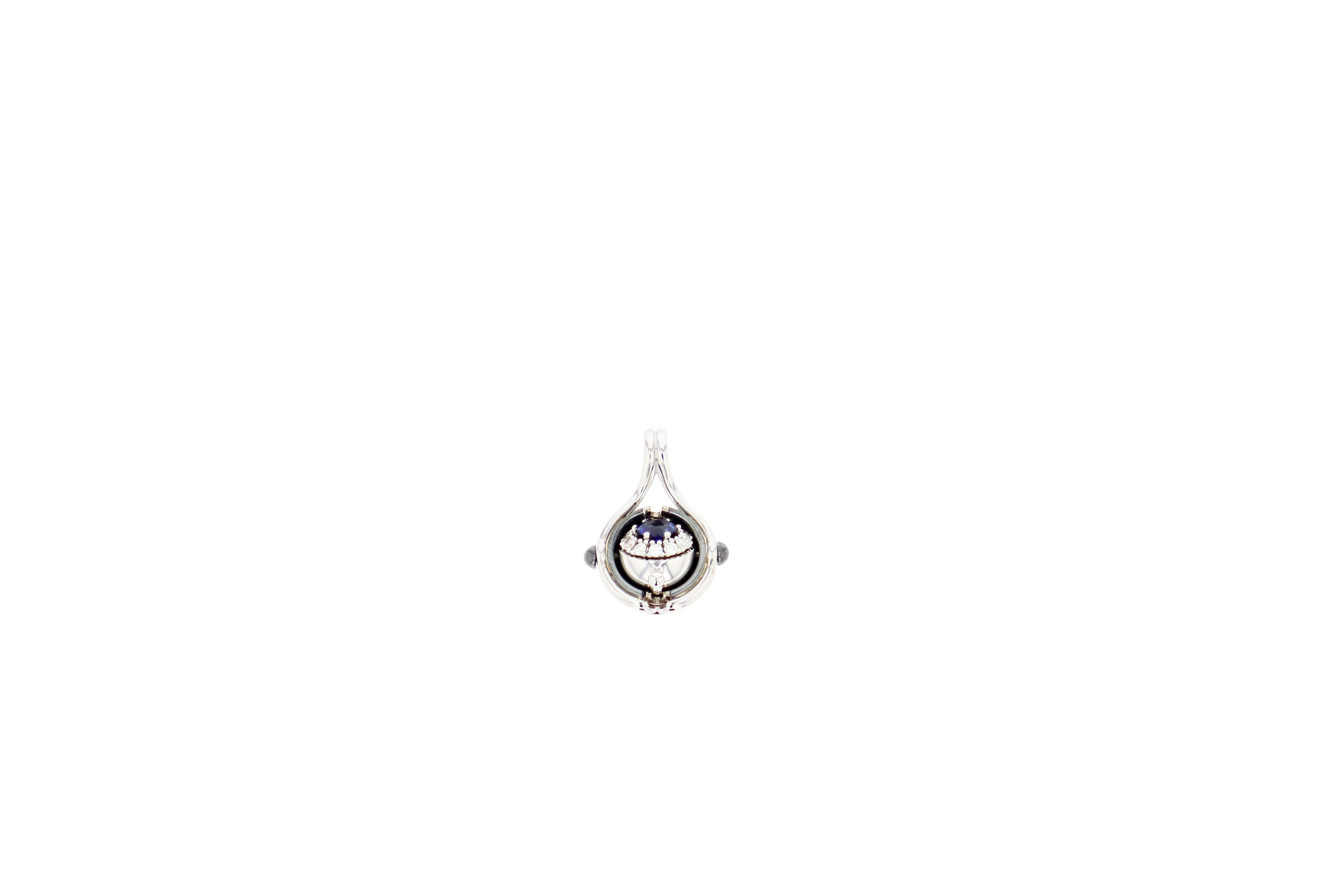 Blue Sapphire Diamonds Mira Pendant Necklace in 18k White Gold by Elie Top. Gold and distressed silver pendant. Rotating sphere revealing a blue sappphire surrounded by diamonds.

Sold with its chain. 

Information : 
Ruby: 0.30 cts 
12 Diamonds: