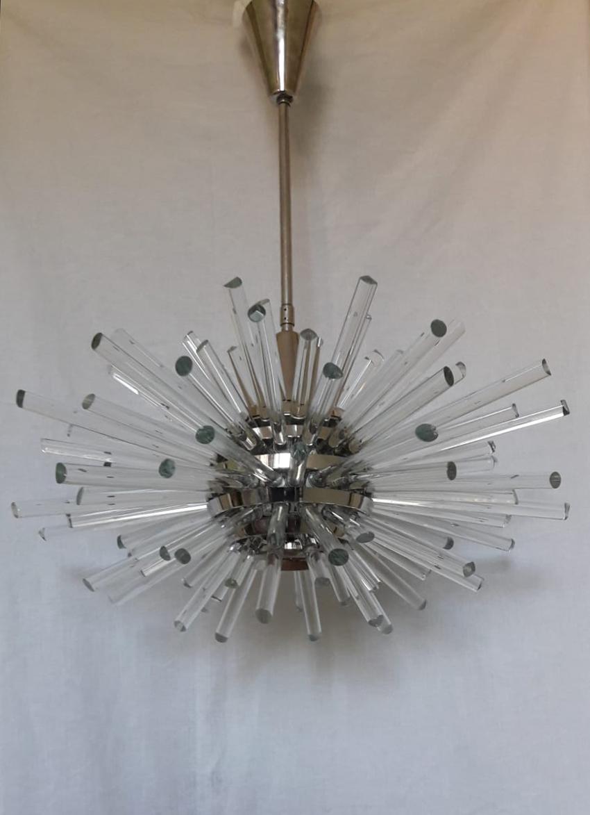 Brass/glass chandelier, 1970s. Brass frame nickel-plated with solid glass rods, glass arches hung all around. Fitted with one E27 socket. Excellent condition! Diameter 40cm, height of the body 50cm plus chain 60cm. 
  