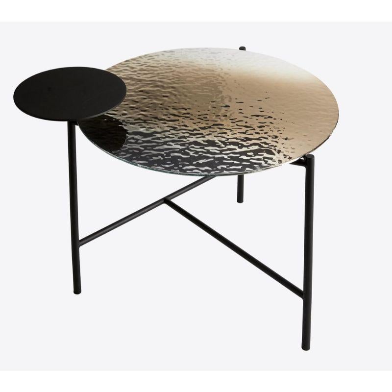 Mirage coffee table by RADAR
Design: Bastien Taillard
Materials: Rippled silver glass top, black matte metal frame.
Dimensions: Total Height: 48 cm, Diameter: glass top / 60 cm, metal top, 25 cm

Also available: In gold and IRIS
