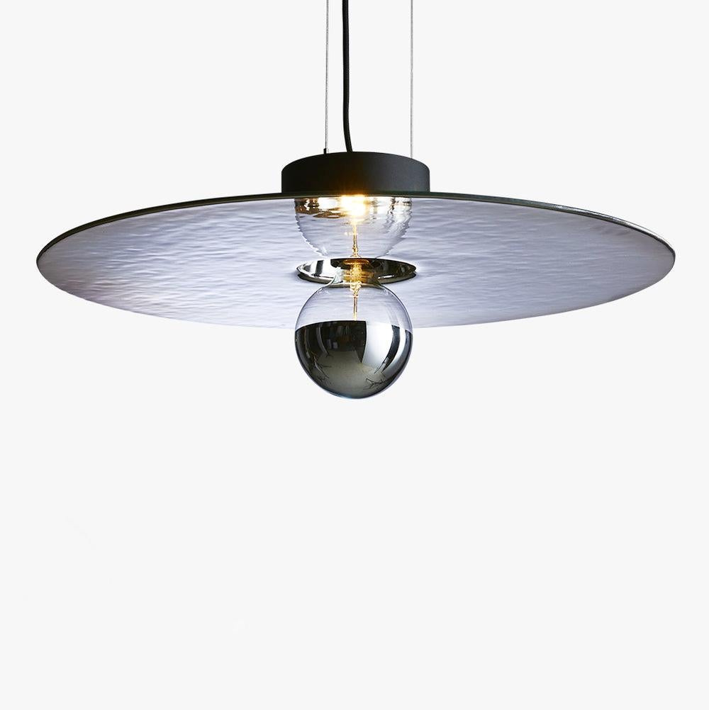 Mirage pendant light, silver & small by RADAR
Design: Bastien Taillard
Materials: Thermoformed silver glass, metal.
Dimensions: H 10 x D 50 cm

Also available: In gold, bronze or iris and size Large (Diameter: 70). Base available in black metal