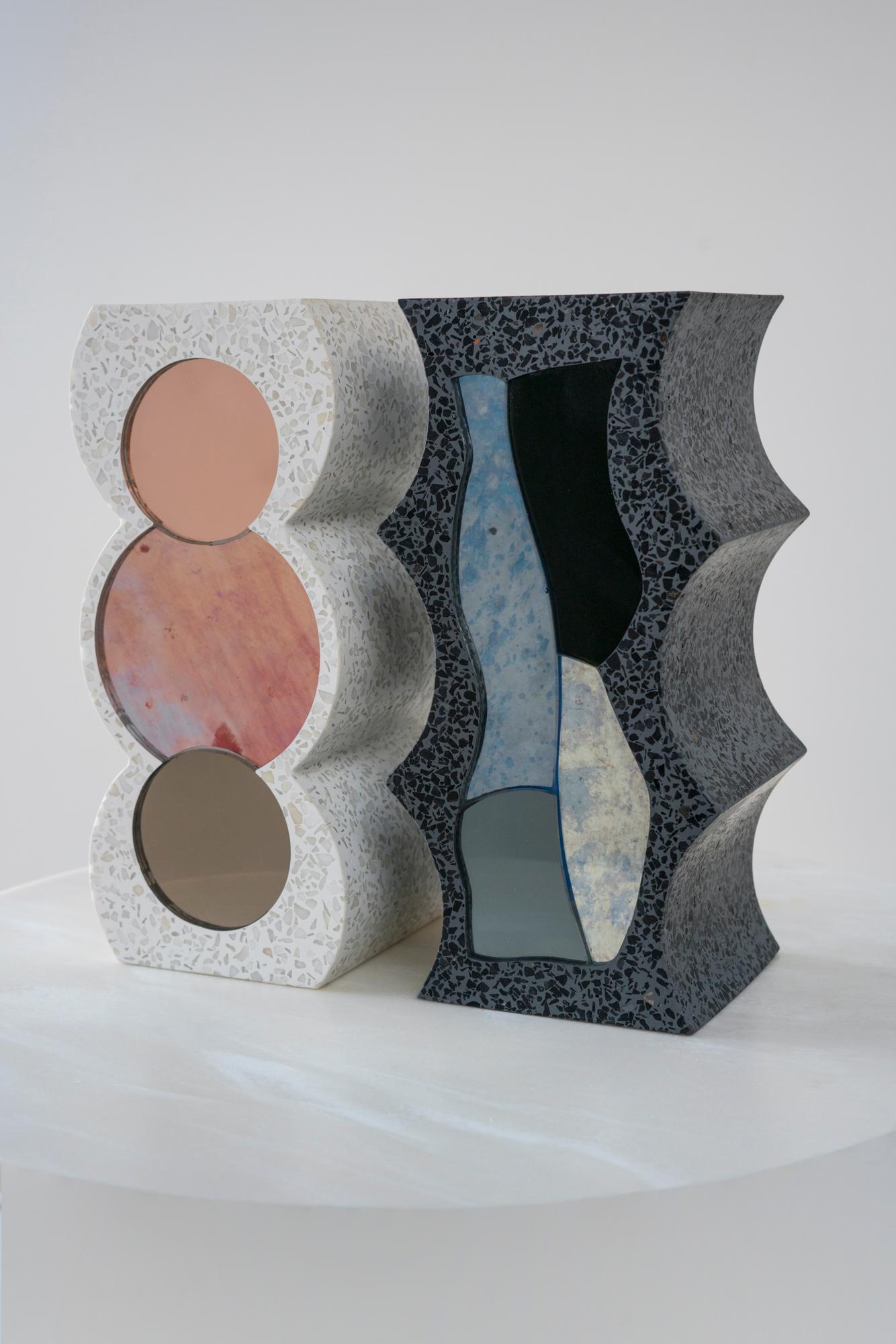 Handcut, colored mirror is cast in graphic shapes with stone terrazzo in a pair of mating bookends.