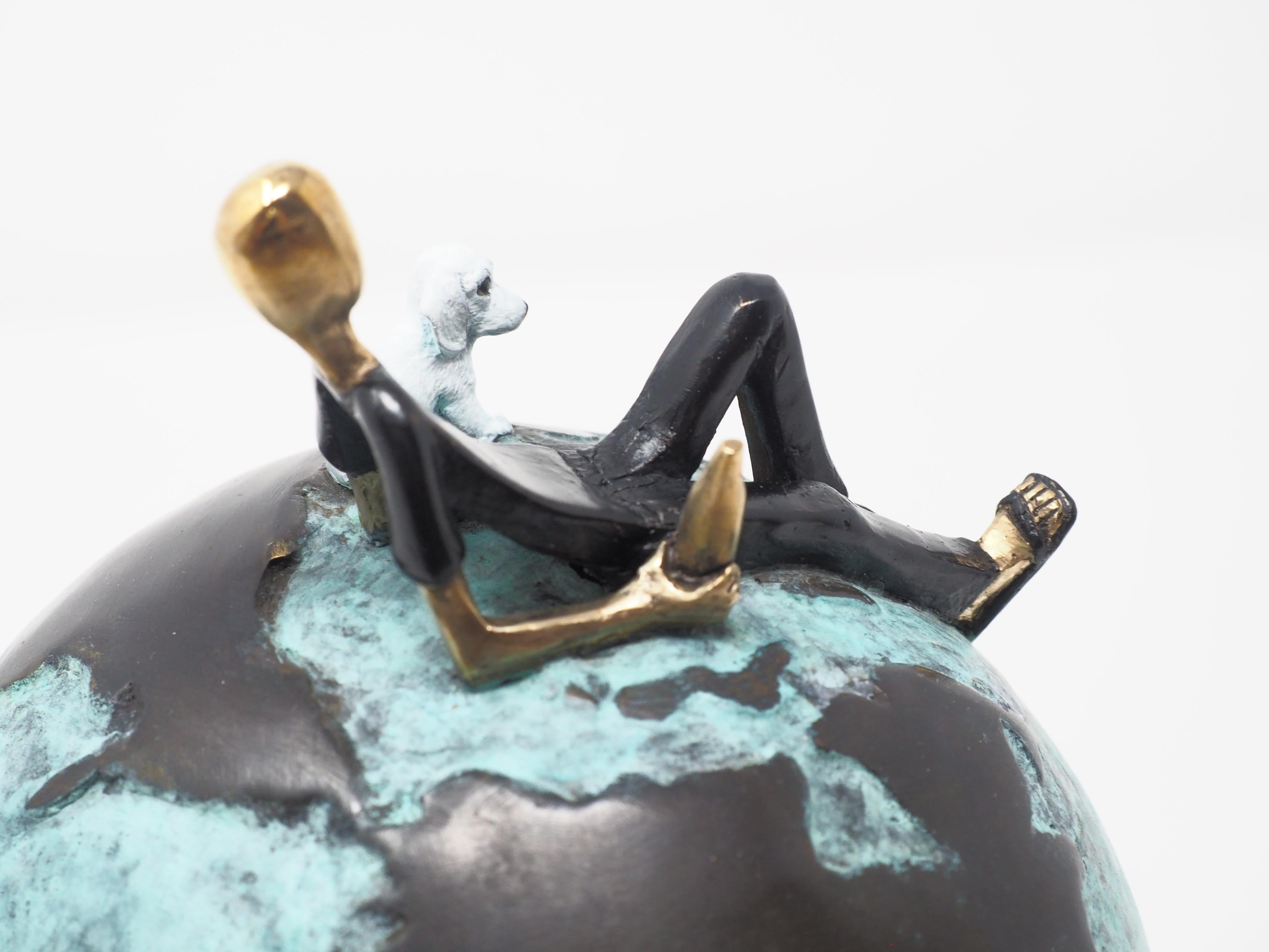 Laid back- figurative bronze sculpture of a man with a dog on a globe - Sculpture by Mireia Serra