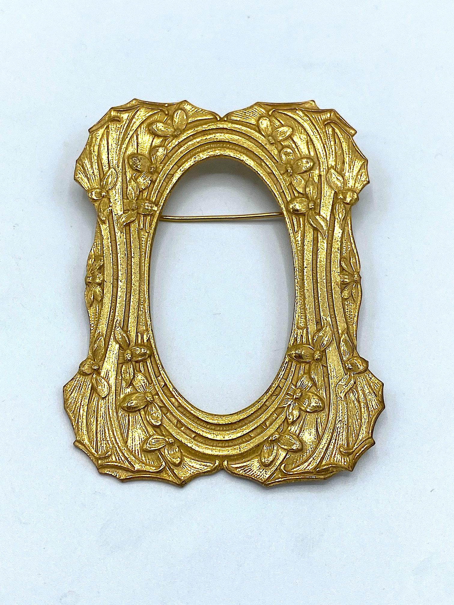 A wonderful Miriam Haskell Art Nouveau picture frame design circa 1960. The frame is carefully embossed in an elongated sweeping pattern ornamented with flowers through out. The edges of the frame are carefully cut around and match the edges of the
