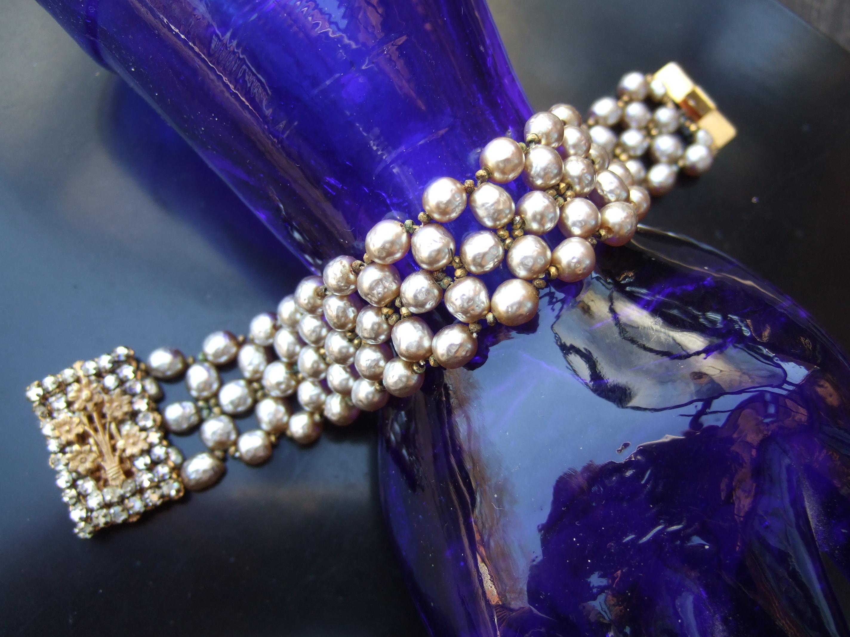 Miriam Haskell Baroque glass enamel pearl bracelet c 1960
The elegant costume bracelet is designed with five rows
of lustrous glass enamel baroque style pearls 

The rectangular clasp medallion is encrusted with glittering 
prong set diamante