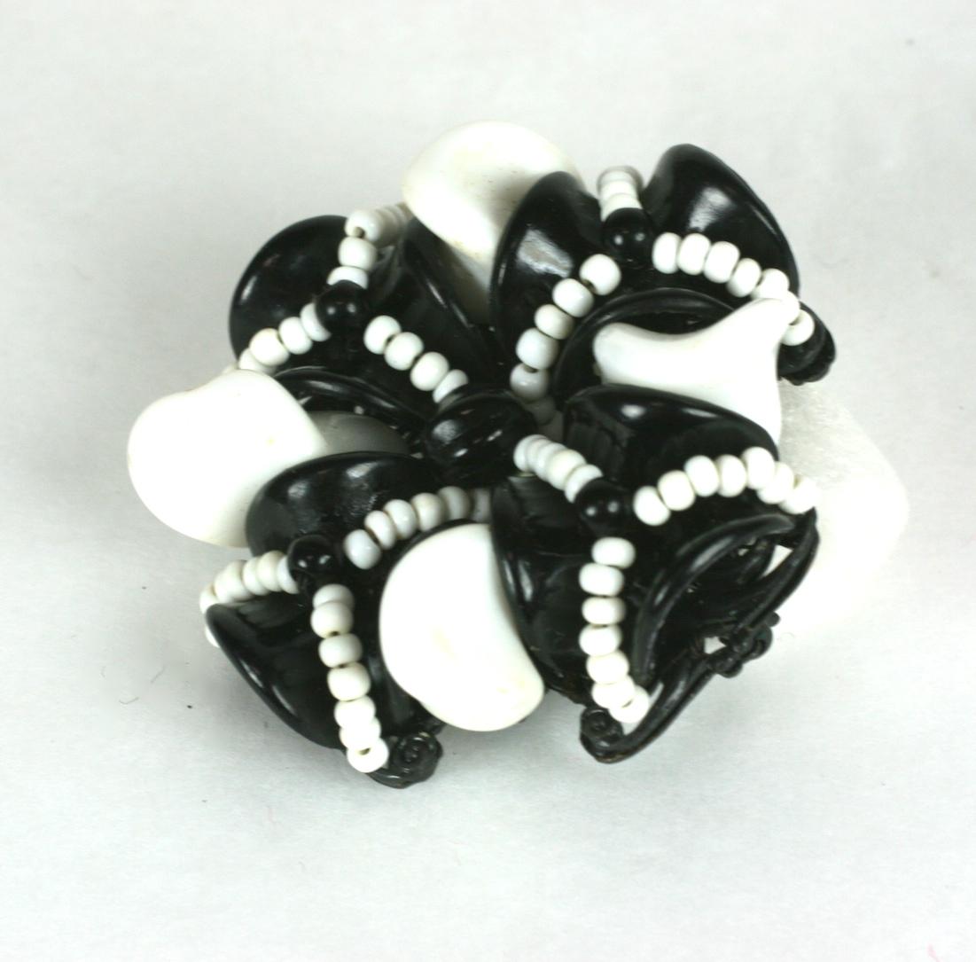 Attractive Miriam Haskell black and white pate de verre Maltese cross style bead brooch. The unusually shaped bead work is hand sewn to a Japanned blackened cross shape signature filigree base. Signed with oval plaque.
Very dimensional brooch.