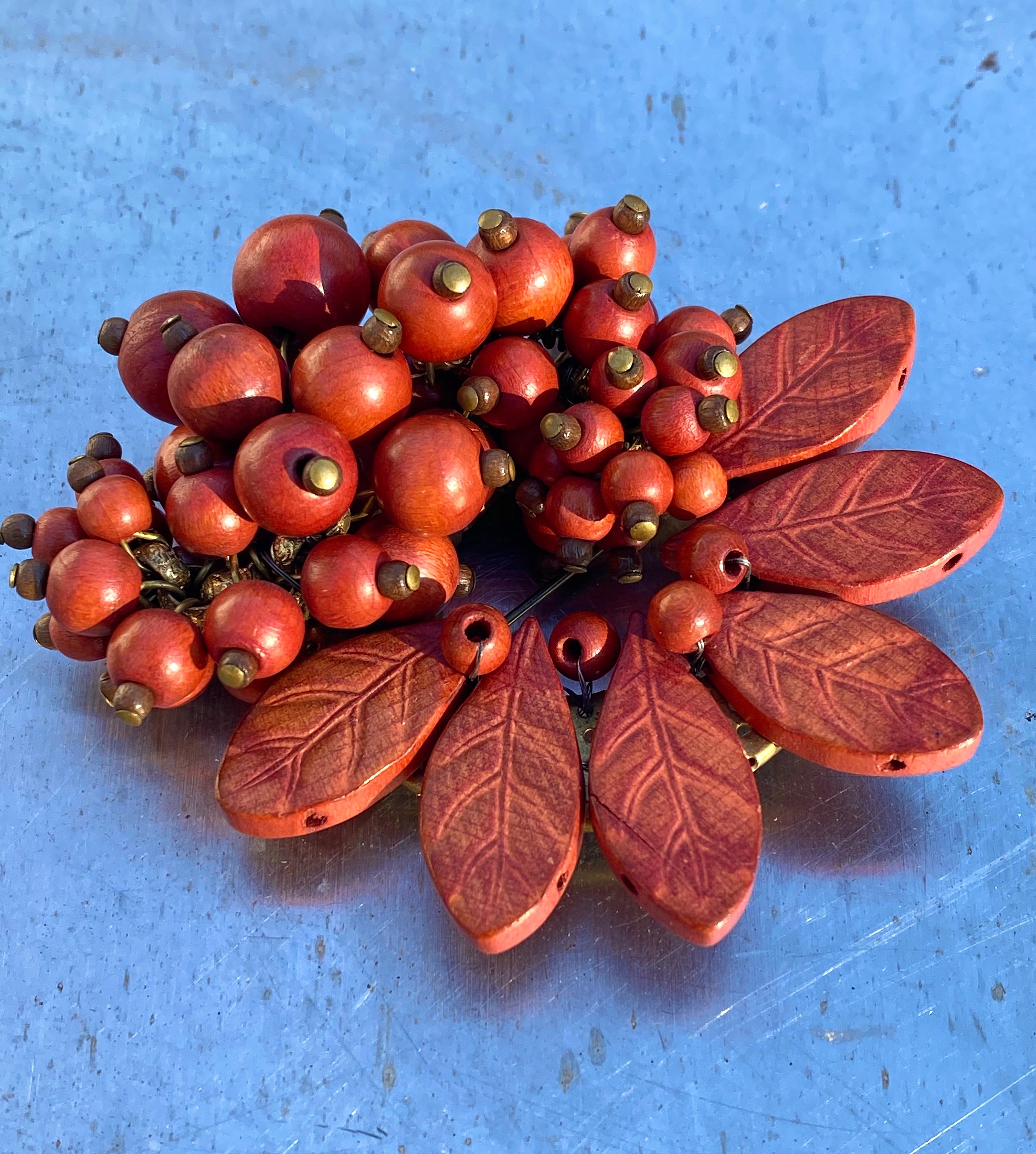 Stunning and Rare 1930's Miriam Haskell Leaf and Berry Brooch in a lush cinnabar cinnamon color.  Made out of wood, this beautiful piece for collectors can be worn in several different directions.   Photographed outside under natural light on a