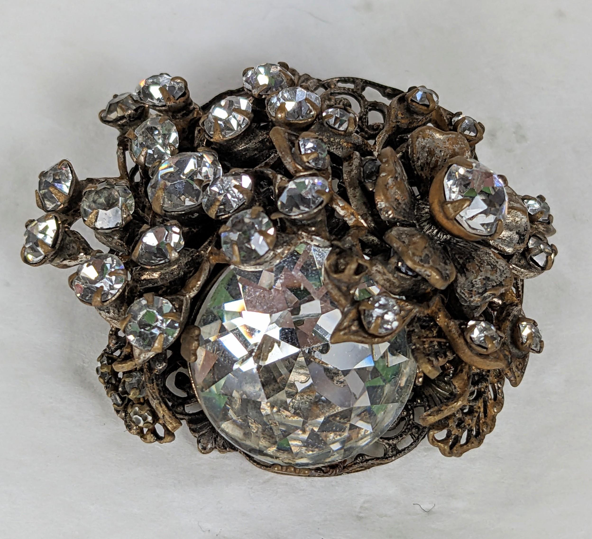 Charming Miriam Haskell Crystal Floral Brooch from the 1950's. Massive Swarovski crystal surrounded by elaborate floral brass filigrees set with a myriad of pastes. 2