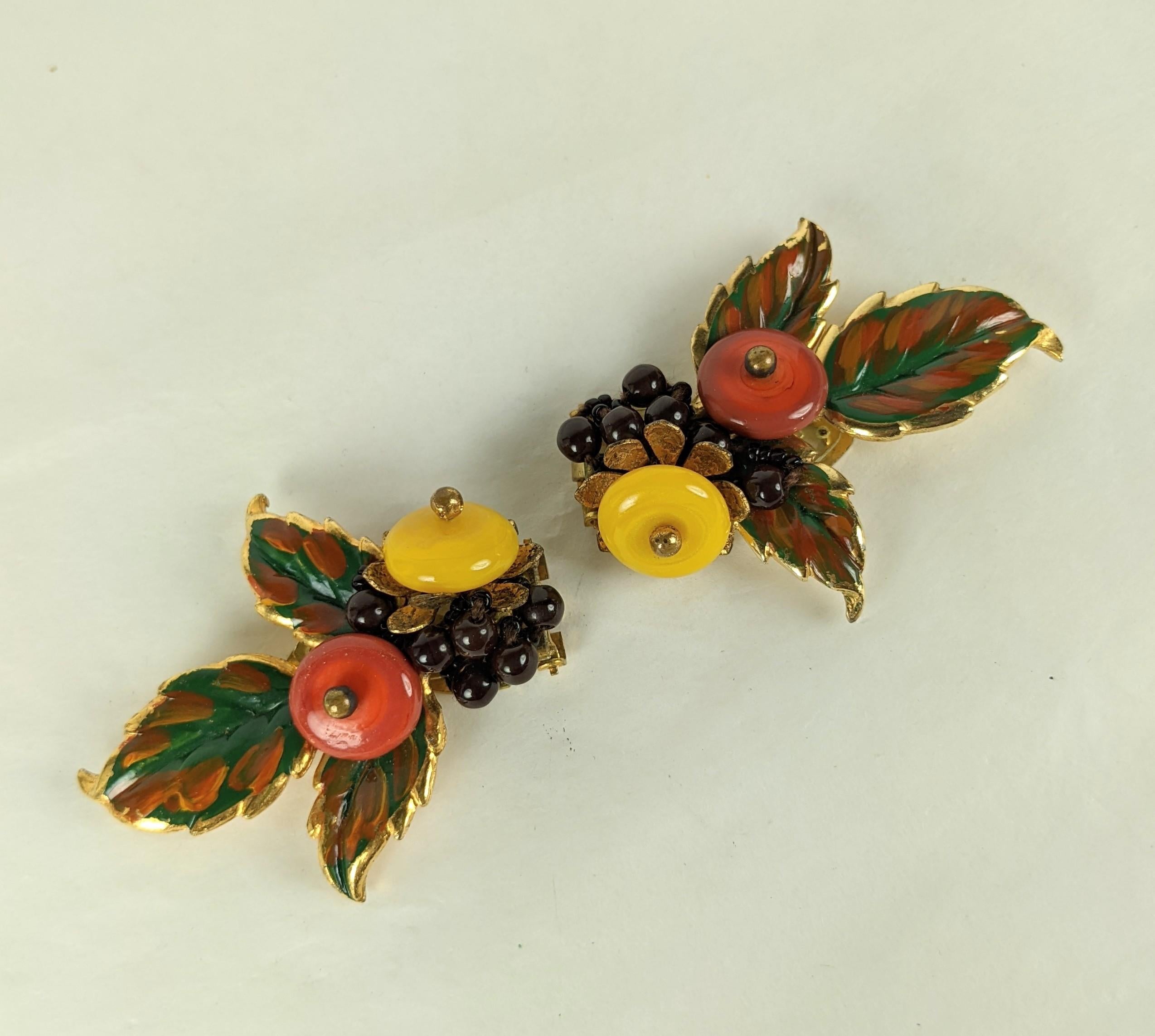 Lovely pair of Miriam Haskell Early Enamel Dress Clips from the 1930's. Gilt enamel metal with hand sewn glass pate de verre beads in mango, rust and brown. Clip back fittings designed to be worn along neckline or lapel, Unsigned early clips. 1930's