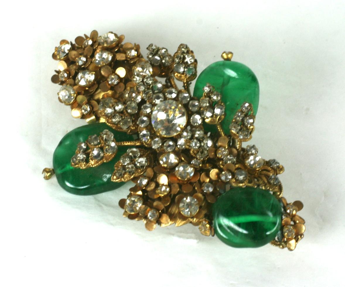 Large Miriam Haskell elaborate bouquet brooch composed of signature Russian Gold plate filigrees with intricate prong set crystal rhinestone vari size flower heads and clusters. Leaf branches are hand sewn with crystal rose montes . 
Flower buds are