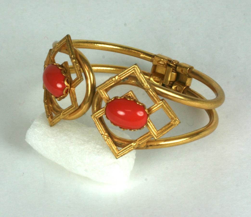 Miriam Haskell faux red coral clamper cuff with spring action closure. 2 textured motifs are each set with a large coral glass cab, all set in the rich signature Haskell Russian gold finish.
1960's USA. Signed.
Excellent condition. 
