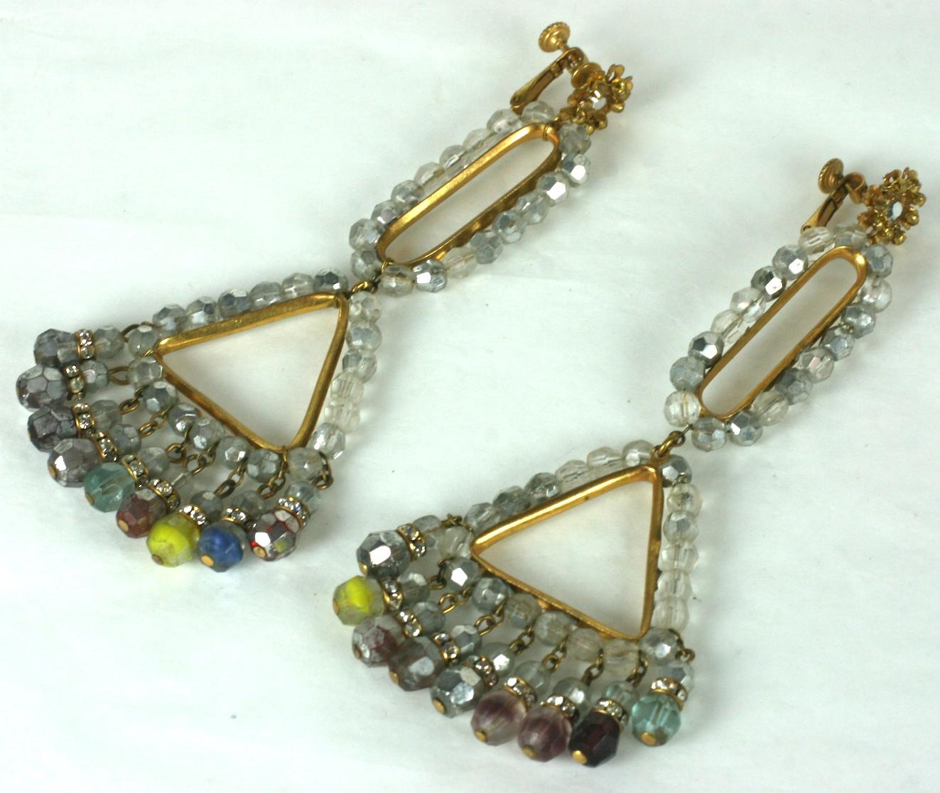 Striking, long Miriam Haskell antique faux smokey quartz long ear clips in signature Russian gilt metal with elongated oval and triangular stations which are channel set with the antiqued grey beads, ending in a fringe of grey and colored beads with