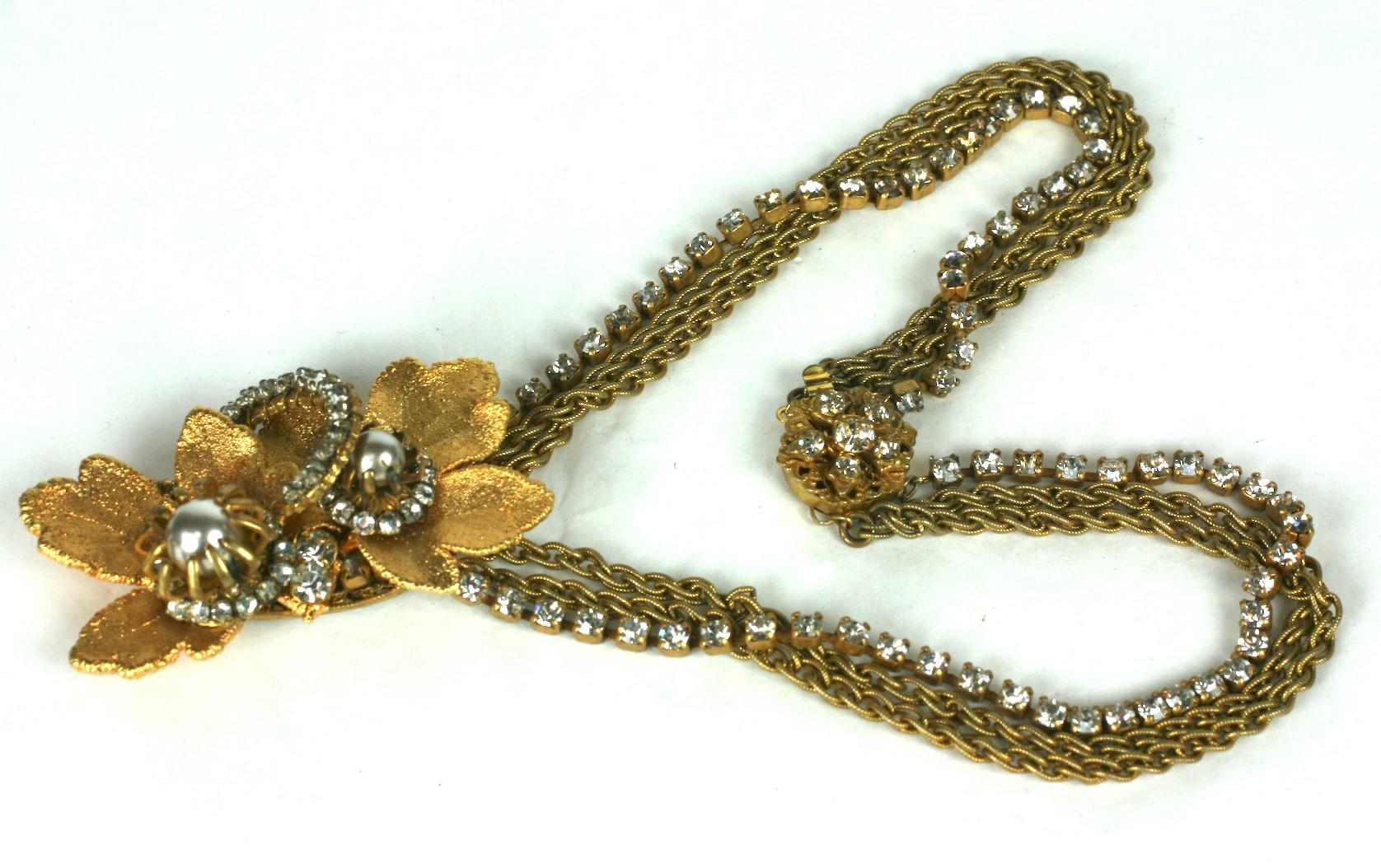 Miriam Haskell Gilt Leaf Pendant Necklace composed of hand sewn rose montees crystals on electroplated leaves and faux pearls. Chaining is of 2 gilt chains mixed with a rhinestone chain.
Signature filigree clasp, signed Miriam Haskell.
1950's USA. 