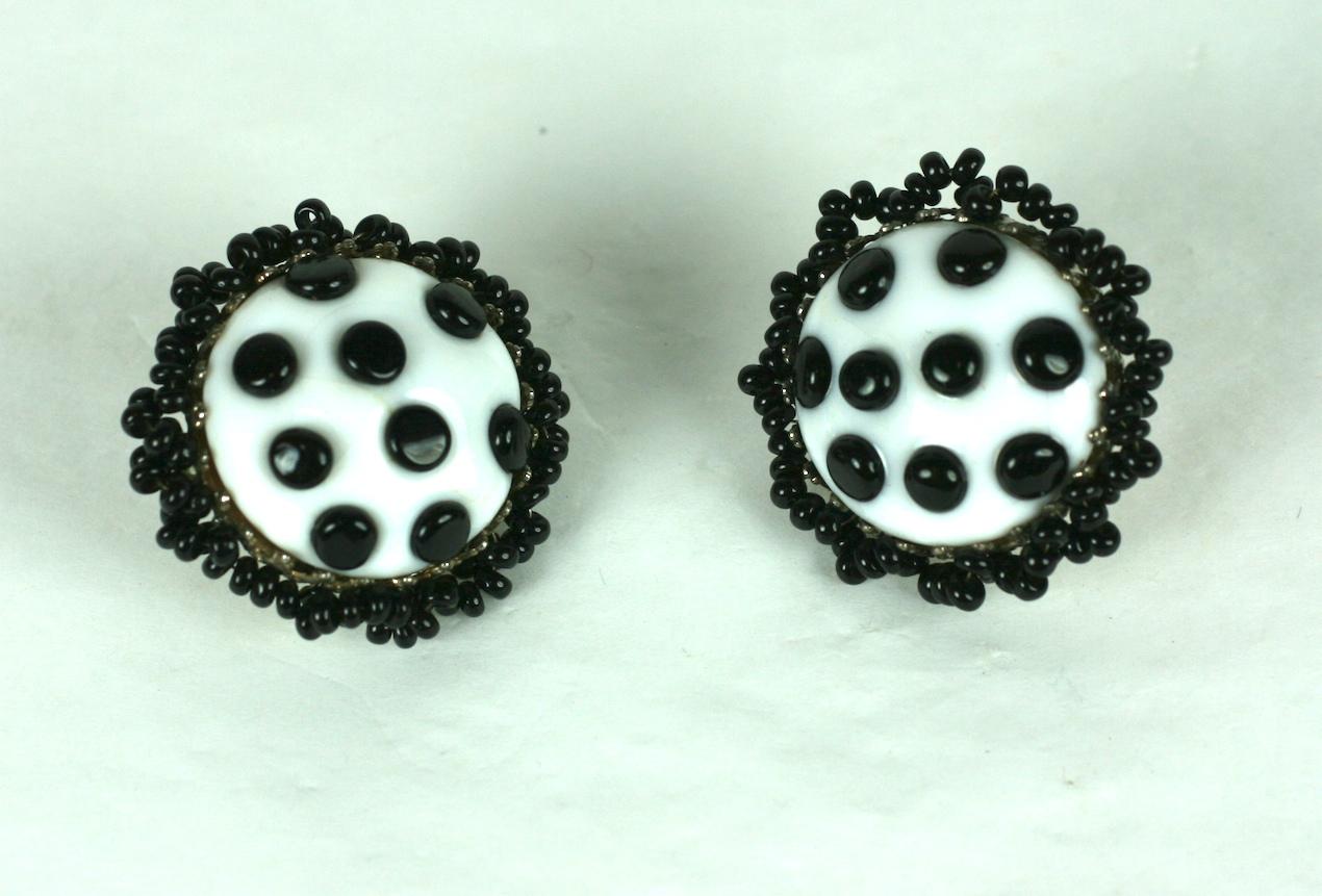 Miriam Haskell Glass Polka Dot Earrings of hand made pate de verre milk glass beads with black glass dot applications. Border of hand sewn jet seed beads. Adjustable clip back fittings.
1950's USA, Signed.
Excellent condition.