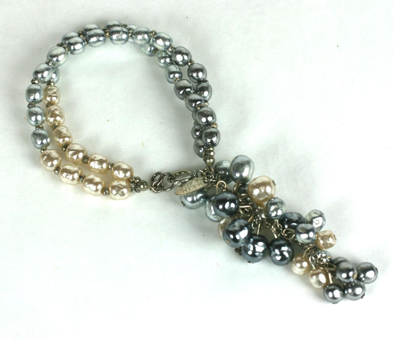 Miriam Haskell grape cascade fob bracelet of a double strand grey and ivory signature baroque pearls.  With elaborate grape cluster fob of vari size faux baroque pearls. 
Excellent Condition.
Length 7