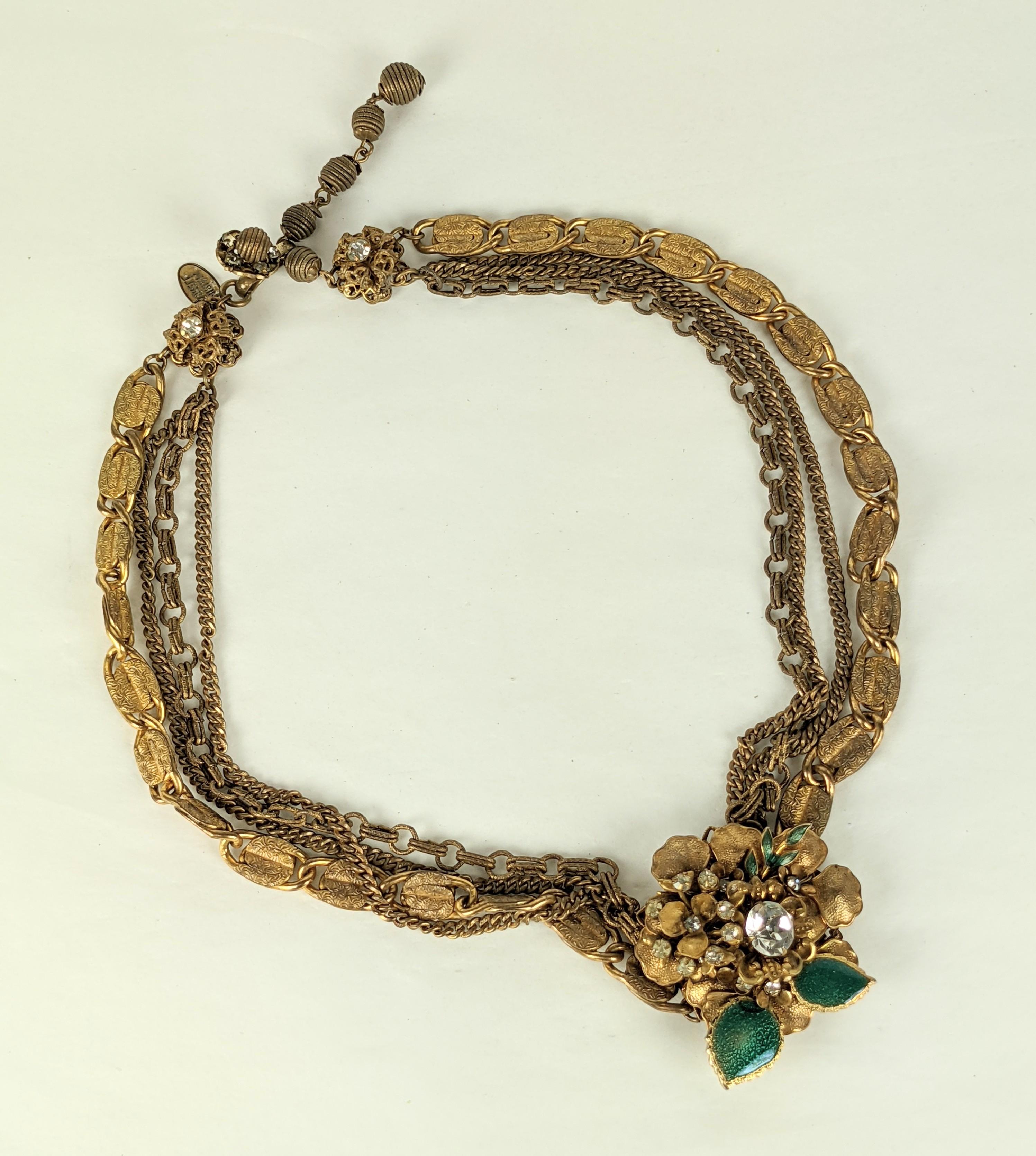 Miriam Haskell Green Enamel and Paste Flower Necklace of varied Russian Gilt chains with central floral station adorned with pastes and green enamel leaves. 
Signed. 1940's USA. Drop 1.5