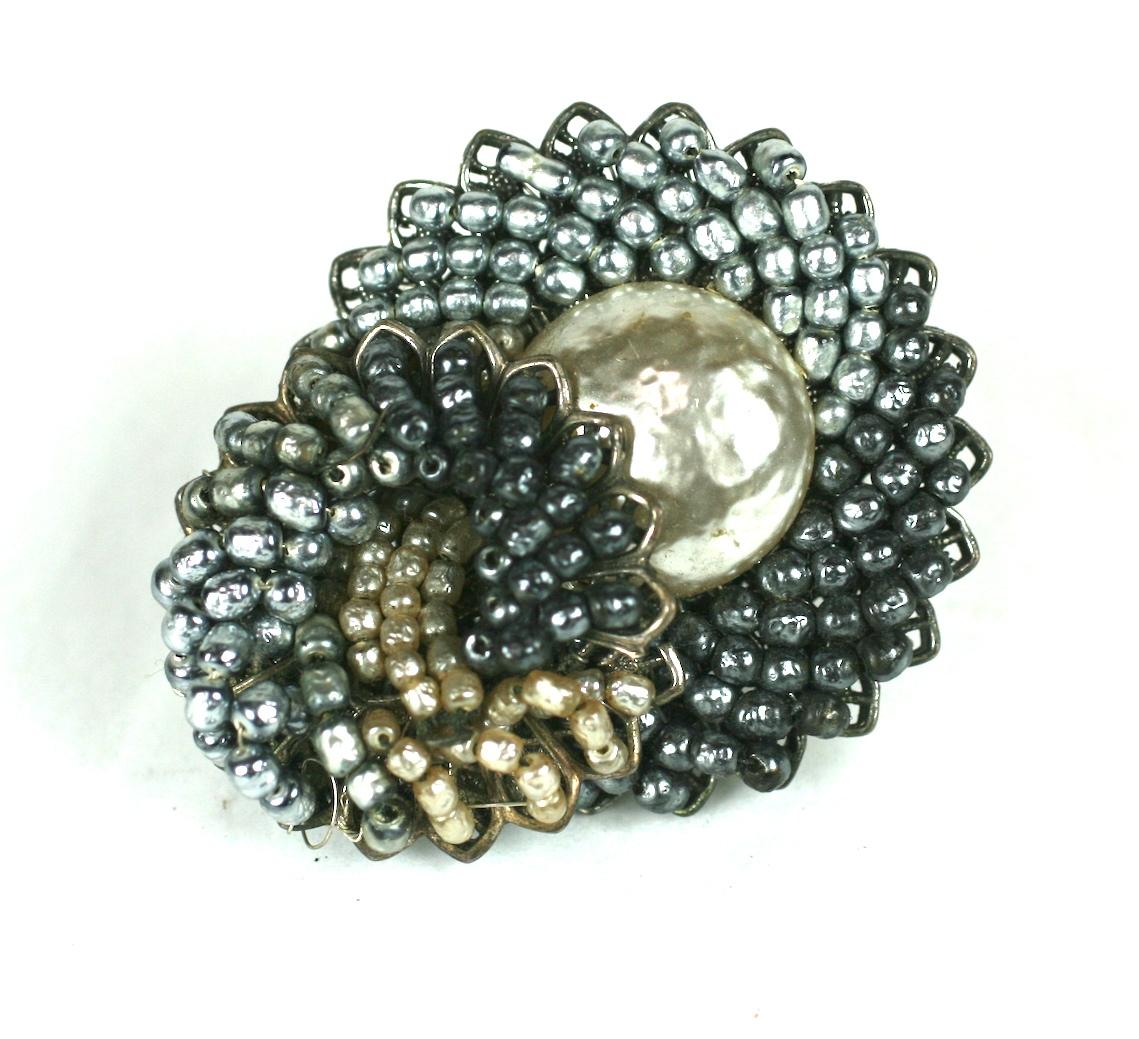 Striking Miriam Haskell Grey Ombre Pearl Brooch composed of hundreds of hand sewn glass pearls onto  a signature filigree base. Wonderful ombre shadings in the pearls within the layers. 
Excellent condition, 1950's USA. Signed.

