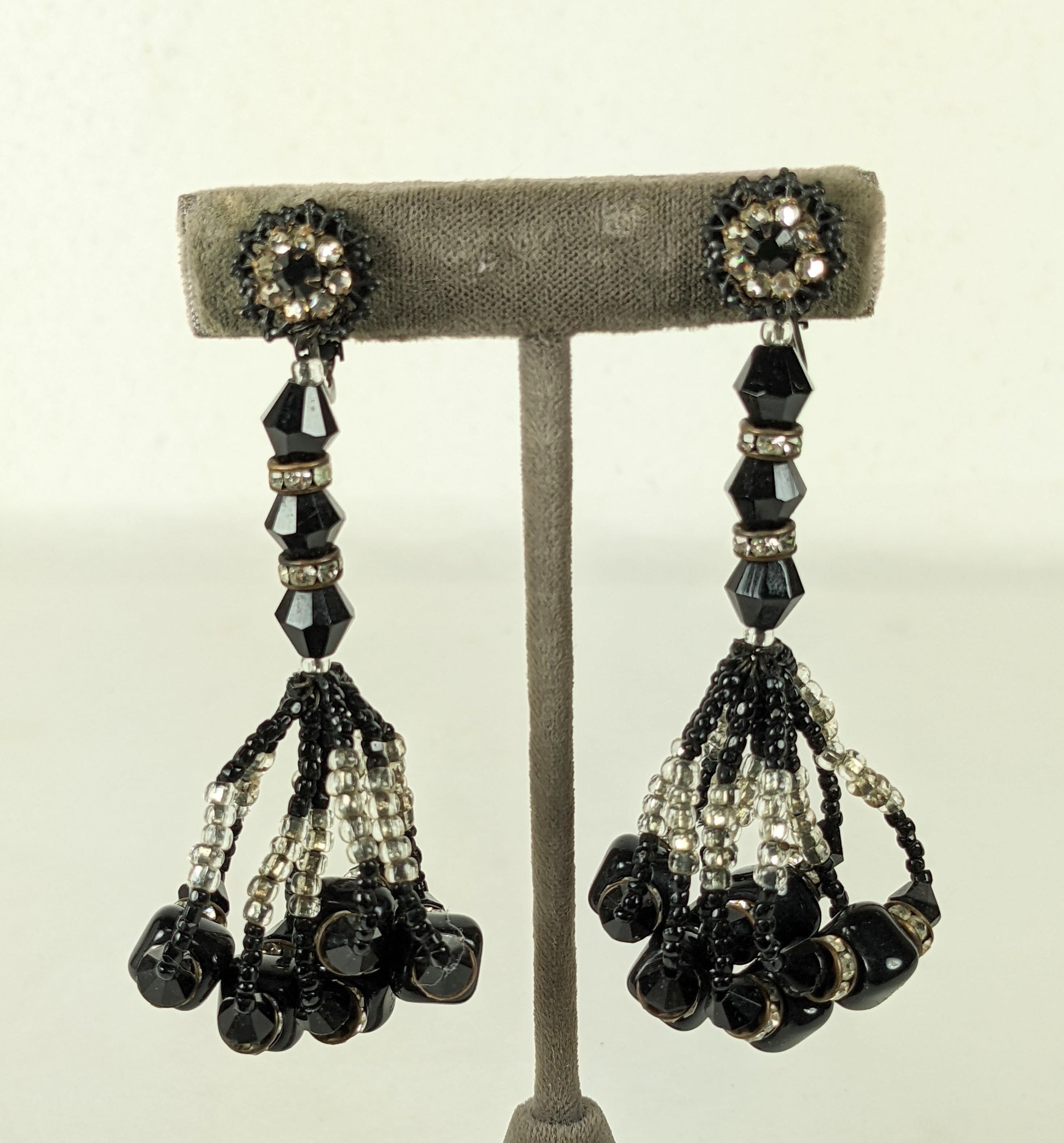 Miriam Haskell Jet and Seed Bead Tassel Earrings from the 1950's. Black jet beads with pave rondels are used to construct a long earring with 5 loops of silver and jet seed beads with larger black pate de verre beads and rondels.  
1950's USA. 
