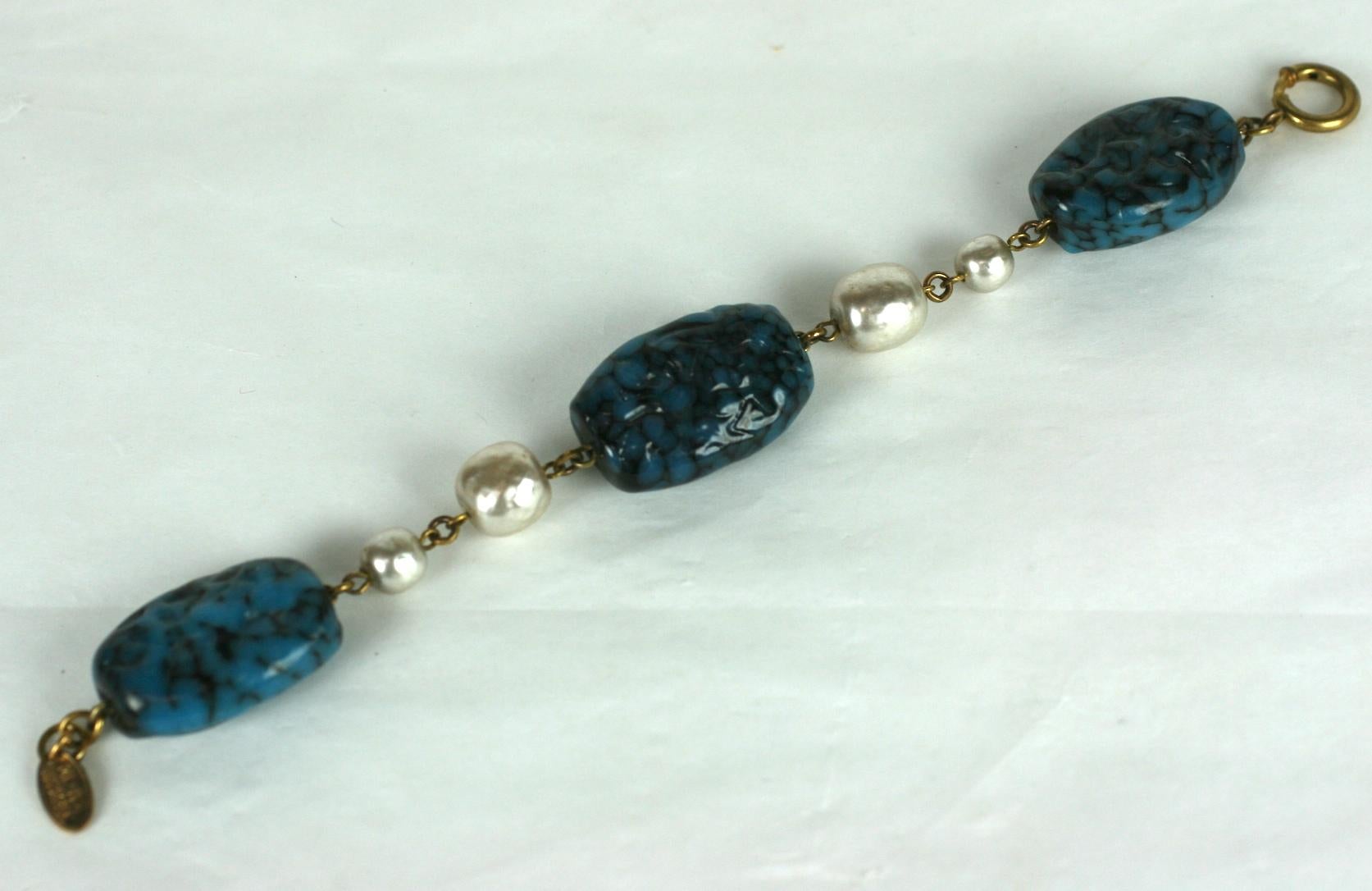 Miriam Haskell pate de verre and faux baroque pearl bracelet composed of three oversized faux lapis Gripoix glass handmade glass beads and two stations of large and medium alternating Miriam Haskell signature faux pearls. 
Excellent Condition,