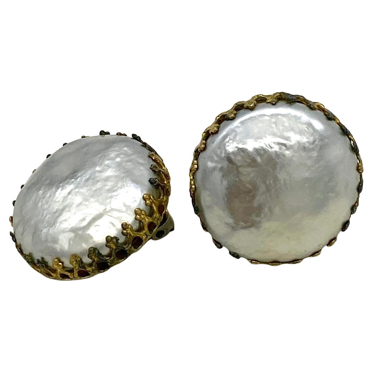 This is a pair of Miriam Haskell pearl clip-on earrings. These single large prong set button pearl earrings are Haskell's well known classic work but now very hard to find in good condition. Here we have a pair of silver gray tone Niki pearls still