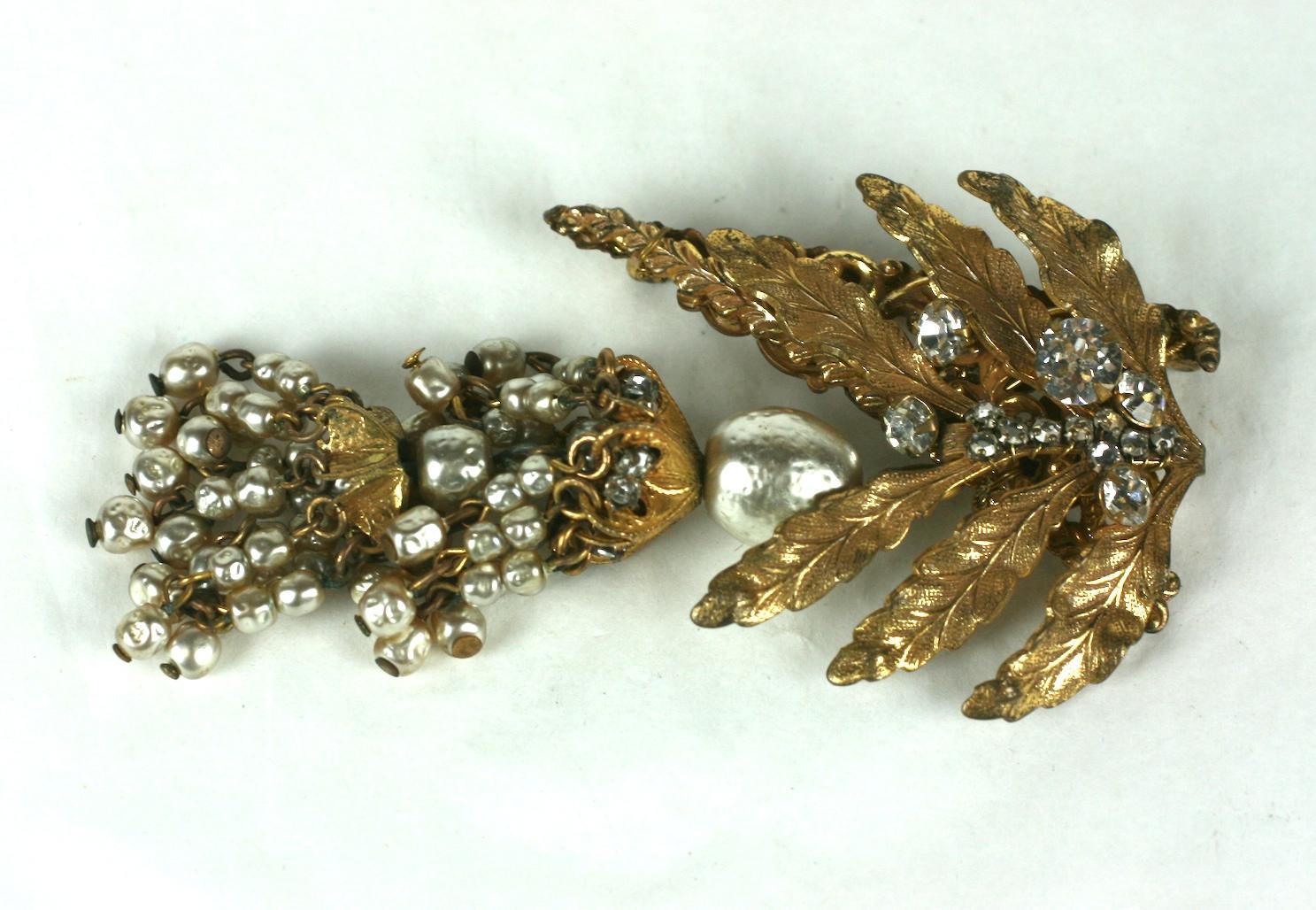 Lovely Haskell Leaf and Pearl Tassel Brooch from the 1940's. Elaborate Haskell signature faux pearls create a tiered tassel which is suspended from a gilt leaf brooch decorated with hand sewn crystals.  
Excellent condition. Signed.   3.5