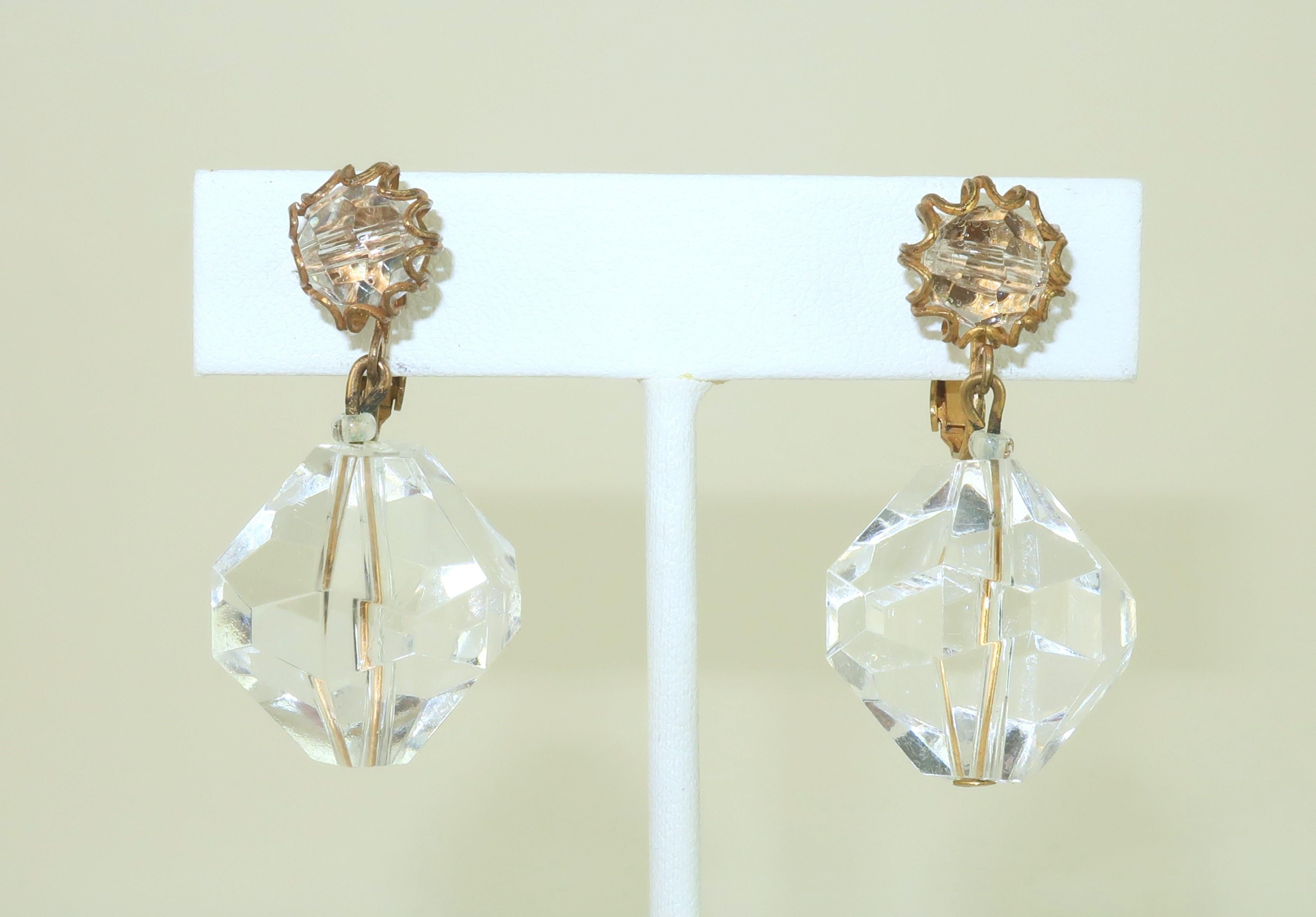 Orecchini pendenti Miriam Haskell degli anni '60, disegnati con una goccia di lucite sfaccettata sospesa da un'altra perla di lucite sfaccettata racchiusa in un filo filigranato.  Gli orecchini catturano la luce e brillano come un cristallo, anche