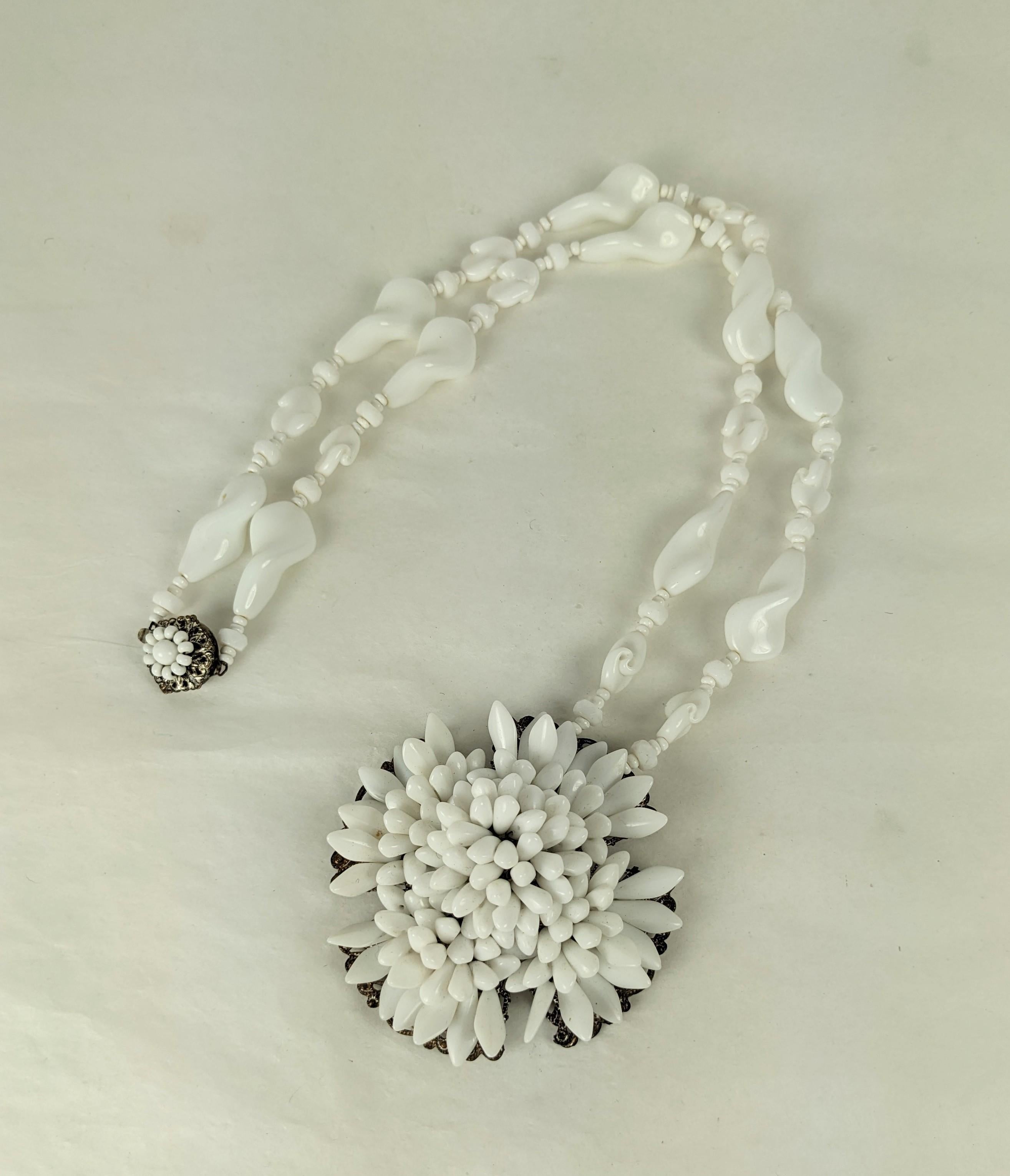 Miriam Haskell Milk Glass Pendant from the 1950's. A filigree base is hand sewn with dozens of milk glass spikes on a necklace of hand made large swirl and seed beads. Signed on clasp. 1950's USA. 
Necklace 24