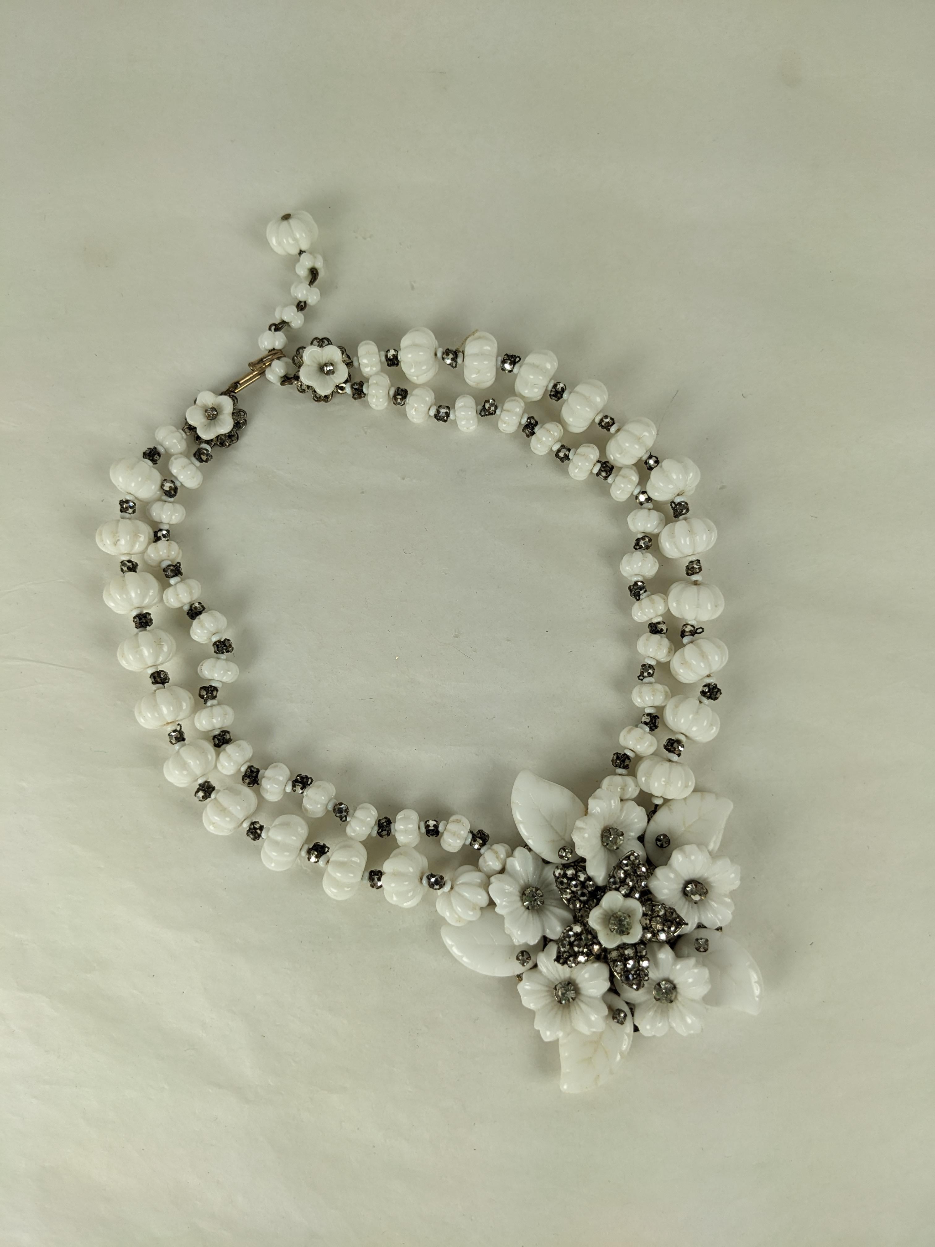 Stunning Miriam Haskell Milk Glass Flower Pendant Necklace from the 1940's. Fluted milk glass beads with hand sewn pave spacers hold a large pendant of poured glass leaves and hand sewn crystals. Signed. 1940's USA. Fits 14-16