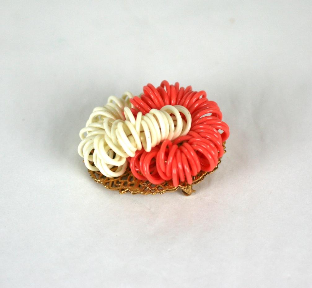 Miriam Haskell Modernist oval brooch. Composed of Signature Russian Gilt filigrees and interlocking spiral rings of faux orange and white coral celluloid.
Excellent Condition, Signed.
Length 2