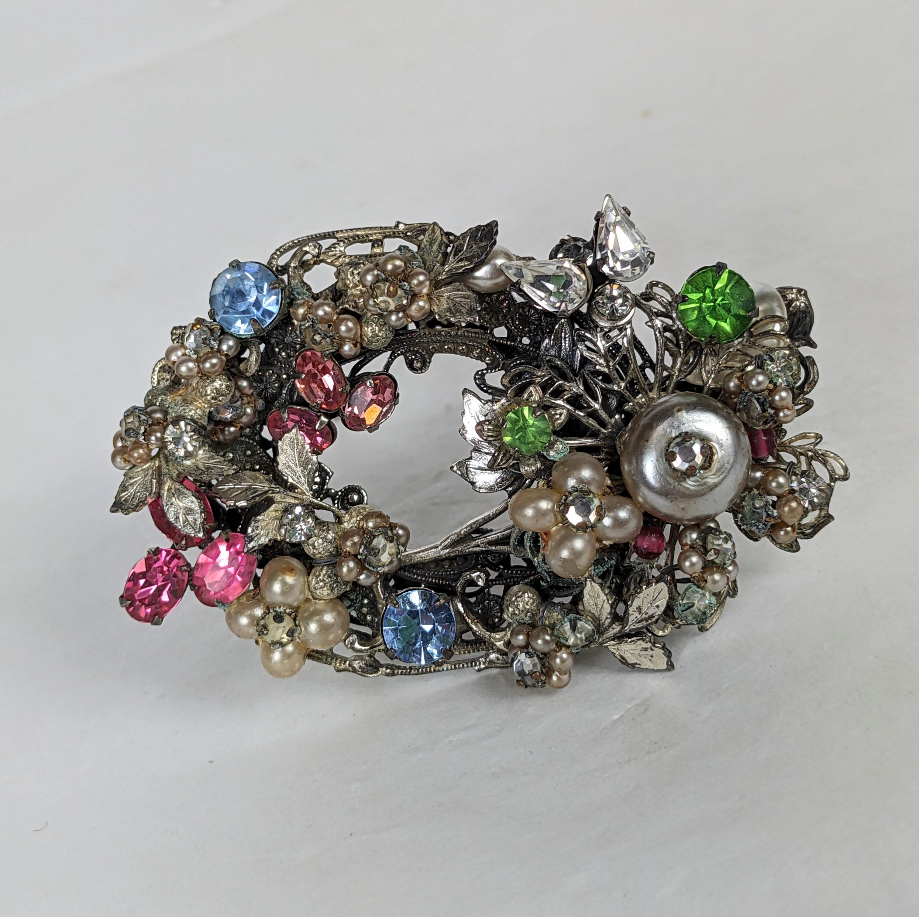 Miriam Haskell Multi Crystal and Faux Pearl Brooch from the 1940's. Silvertone filigree hand embroidered brooch with multicolored crystals and faux pearls. 1940's USA. Unsigned early piece. 2.35