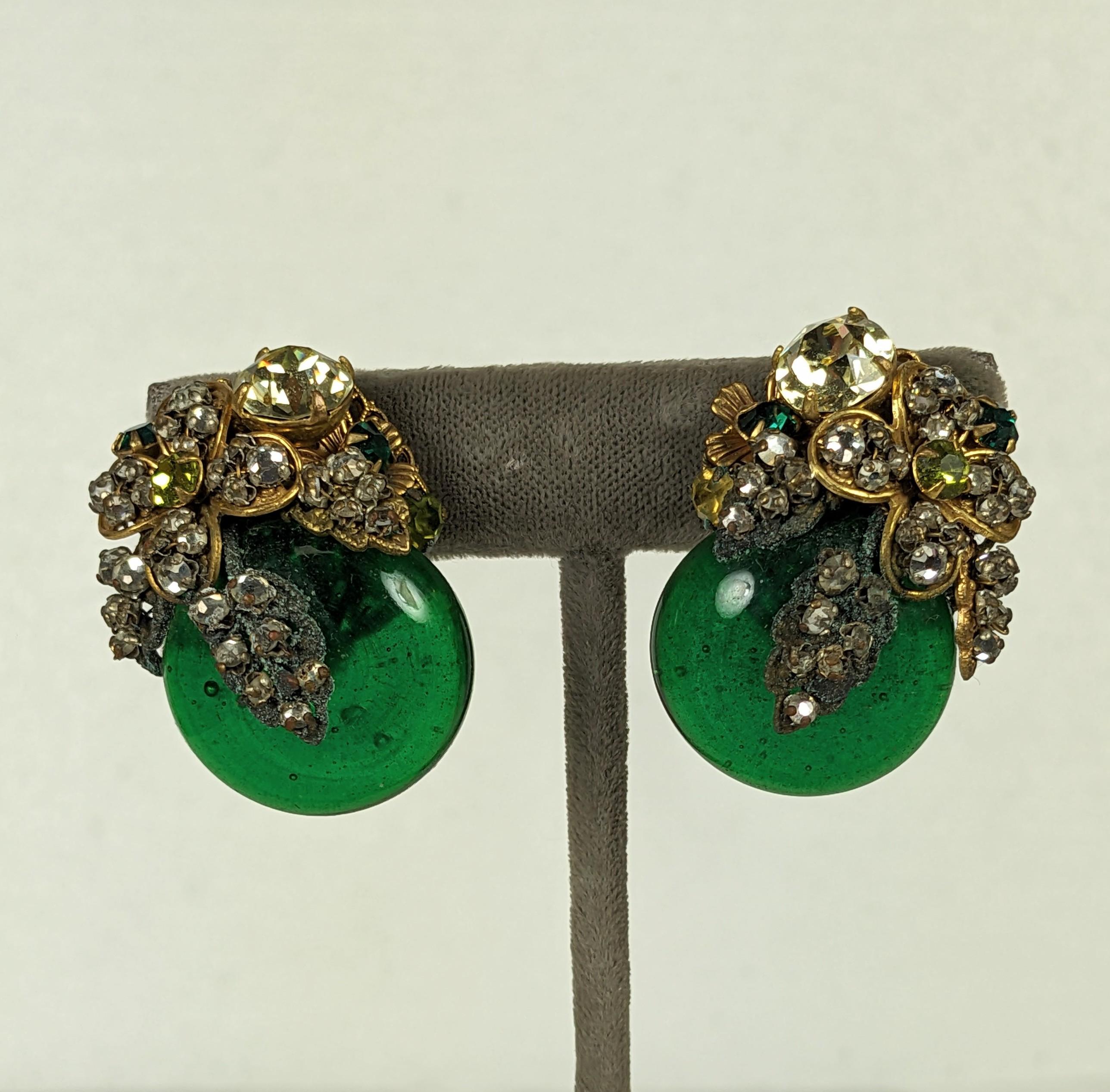 Miriam Haskell Ornate Emerald Gripoix Glass Earrings from the 1950's. Large emerald pate de verre cabs are embroidered with stones on Russian gilt filigrees in citrine, emerald, peridot and crystal. Superb hand made quality and striking size. 1 3/8