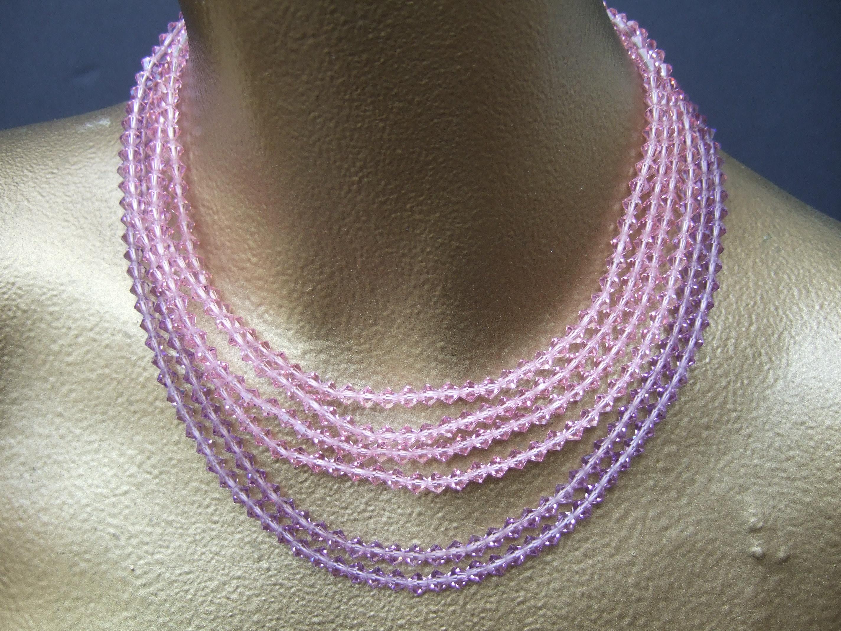 MIRIAM HASKELL Pastel multi-strand crystal necklace & clip on button earrings c 1960
The chocker style necklace is designed with six rows of graduated glittering pastel crystals 
Four of the graduated strands are pale pink, two strands are lavender