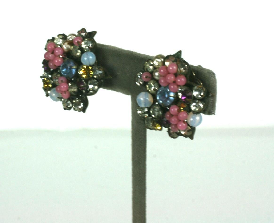 Miriam Haskell Pastel Flower Earrings in antiques silver metal. Pastel beads are mixed with crystals and faux pearls. Clip back fittings. 
1940's USA.  Excellent condition. 
1