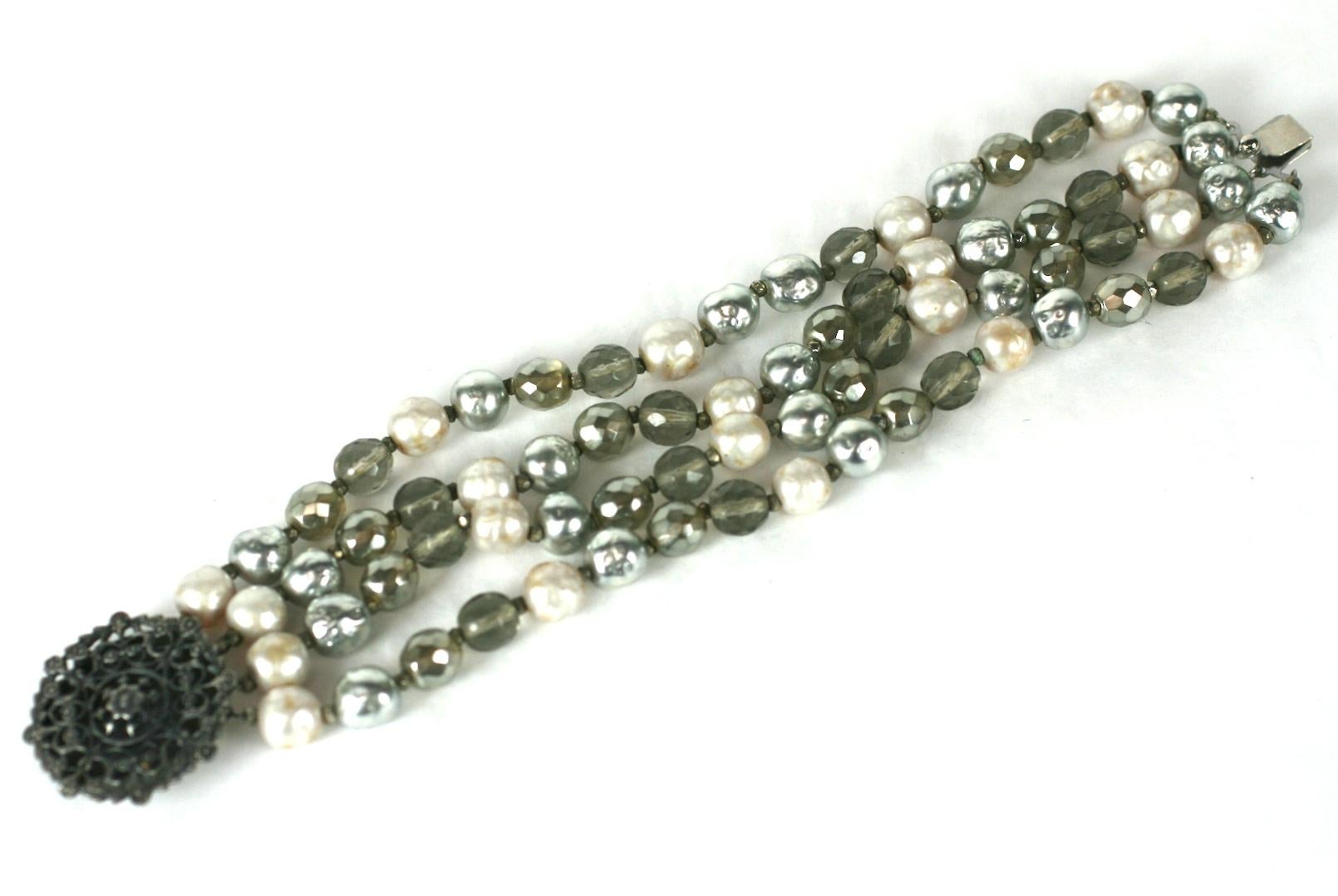 Miriam Haskell Perlen- und Kristallperlenarmband. 4 Strang Armband mit faux Creme, grauen Perlen und rauchigen Kristallperlen. Filigraner Verschluss aus Altsilber. 
7.5